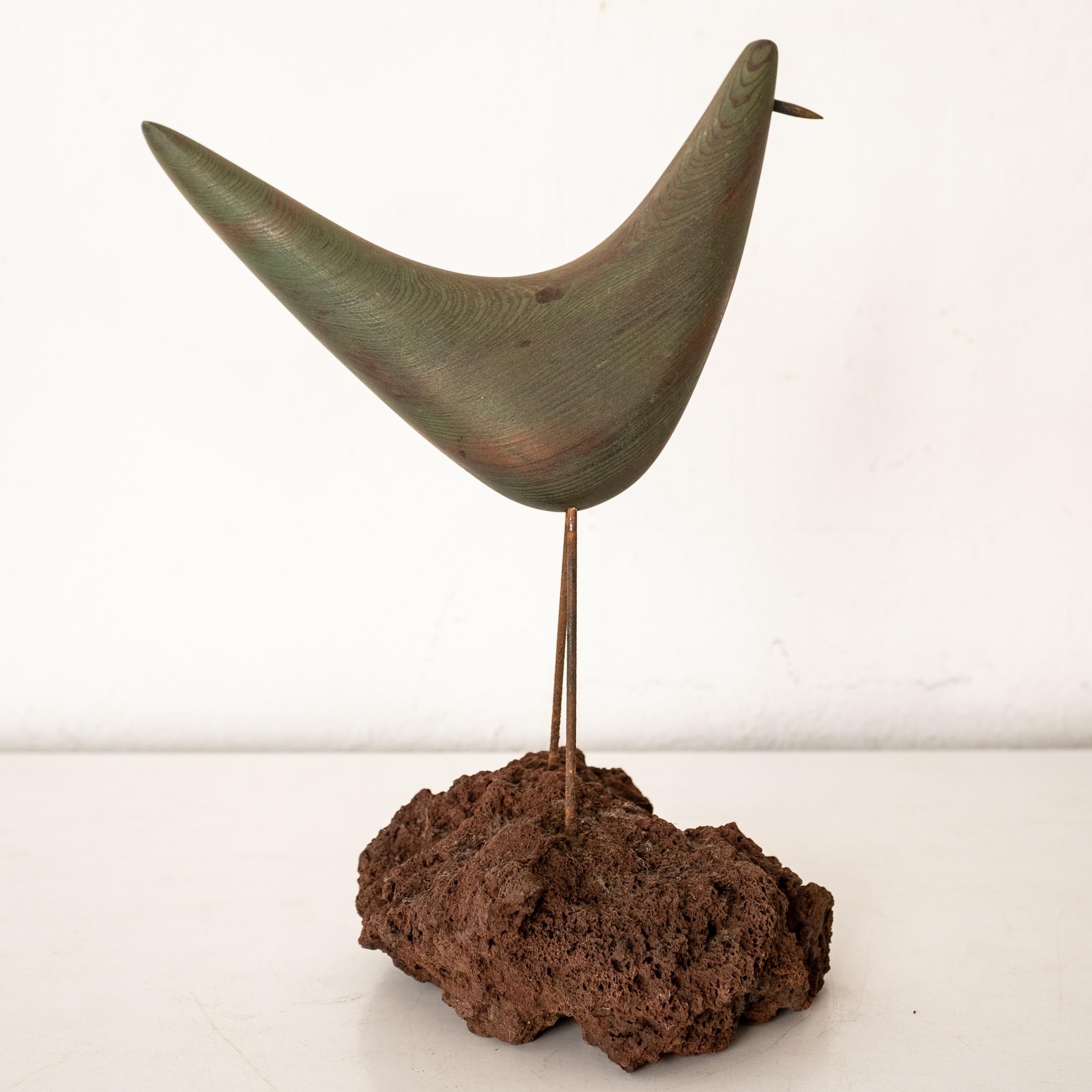 A fantastic stylized wood bird sculpture. Brass beak and natural stone base. 1950s.
 