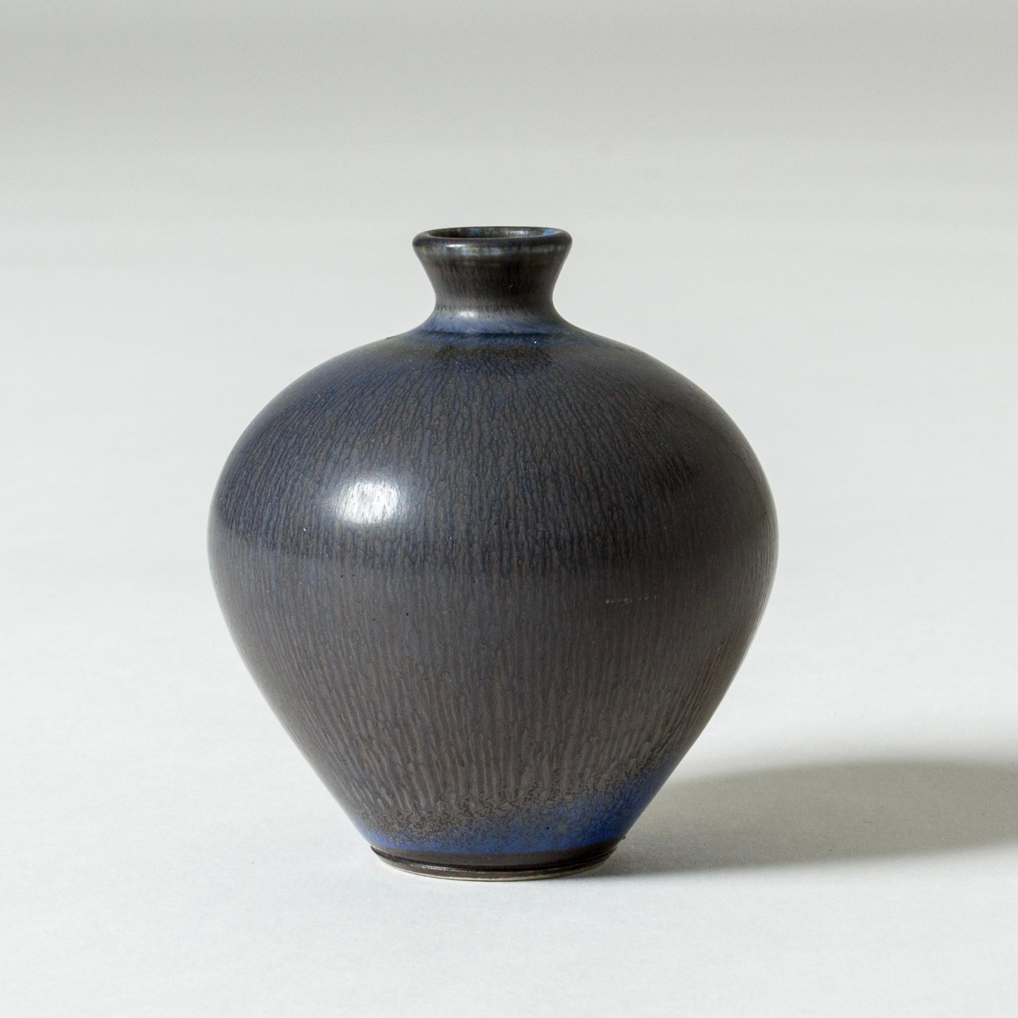 Miniature stoneware vase by Berndt Friberg in a plump apple form. Vibrant blue hare’s fur glaze.

Berndt Friberg was a Swedish ceramicist, renowned for his stoneware vases and vessels for Gustavsberg. His pure, composed designs with satiny,
