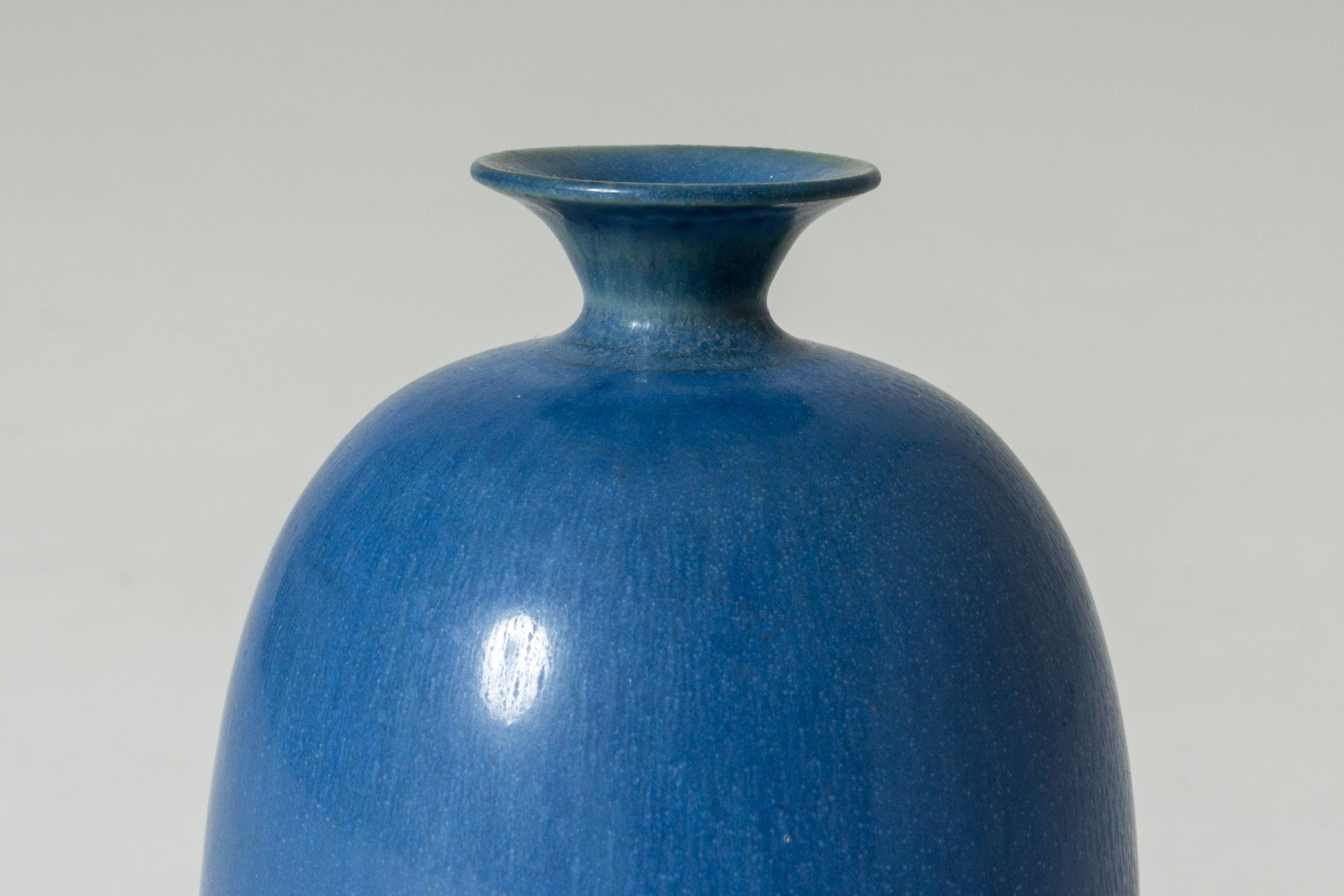 Lovely small stoneware vase by Berndt Friberg, in a buckthorn form with a small widening neck. Clear blue hare’s fur glaze.

Berndt Friberg was a Swedish ceramicist, renowned for his stoneware vases and vessels for Gustavsberg. His pure, composed