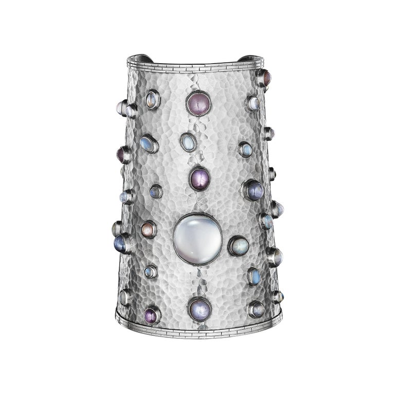 Get cuffed!  This modernist handmade moonstone hammered sterling silver wide cuff will do just that.  With one large captivating center moonstone surrounded by 40 assorted size moonstones, all bezel set, this cuff is the one-of-a-kind statement