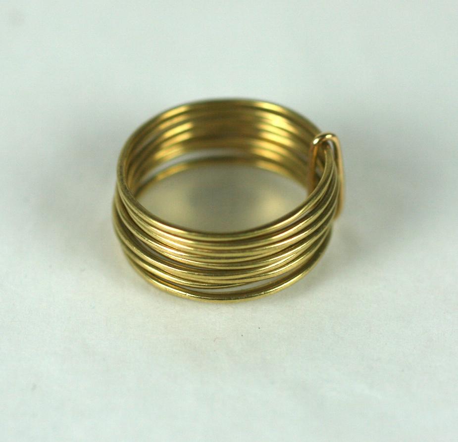 Modernist Multi Hoop Ring, Elegant thin hoops of 14k gold are held by a flattened back loop. The ring looks great when worn and falls loose when removed, like a puzzle ring.
Approx .5
