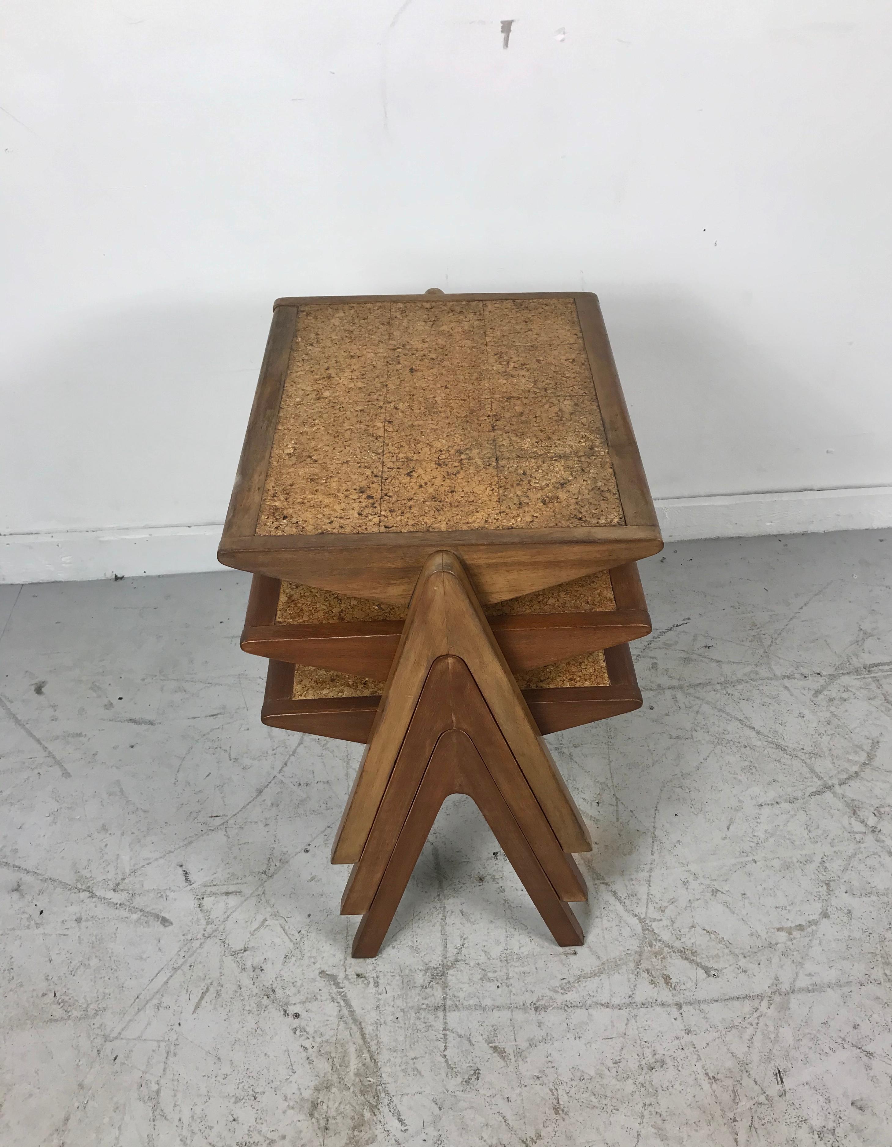 A stylish set of nesting tables designed by Bob Roukema for Jon Jansen in New Zealand, circa 1950s. This stunning set of three nesting tables feature a walnut-stained mahogany frame with its original cork tiled design on rectangular tops and compass