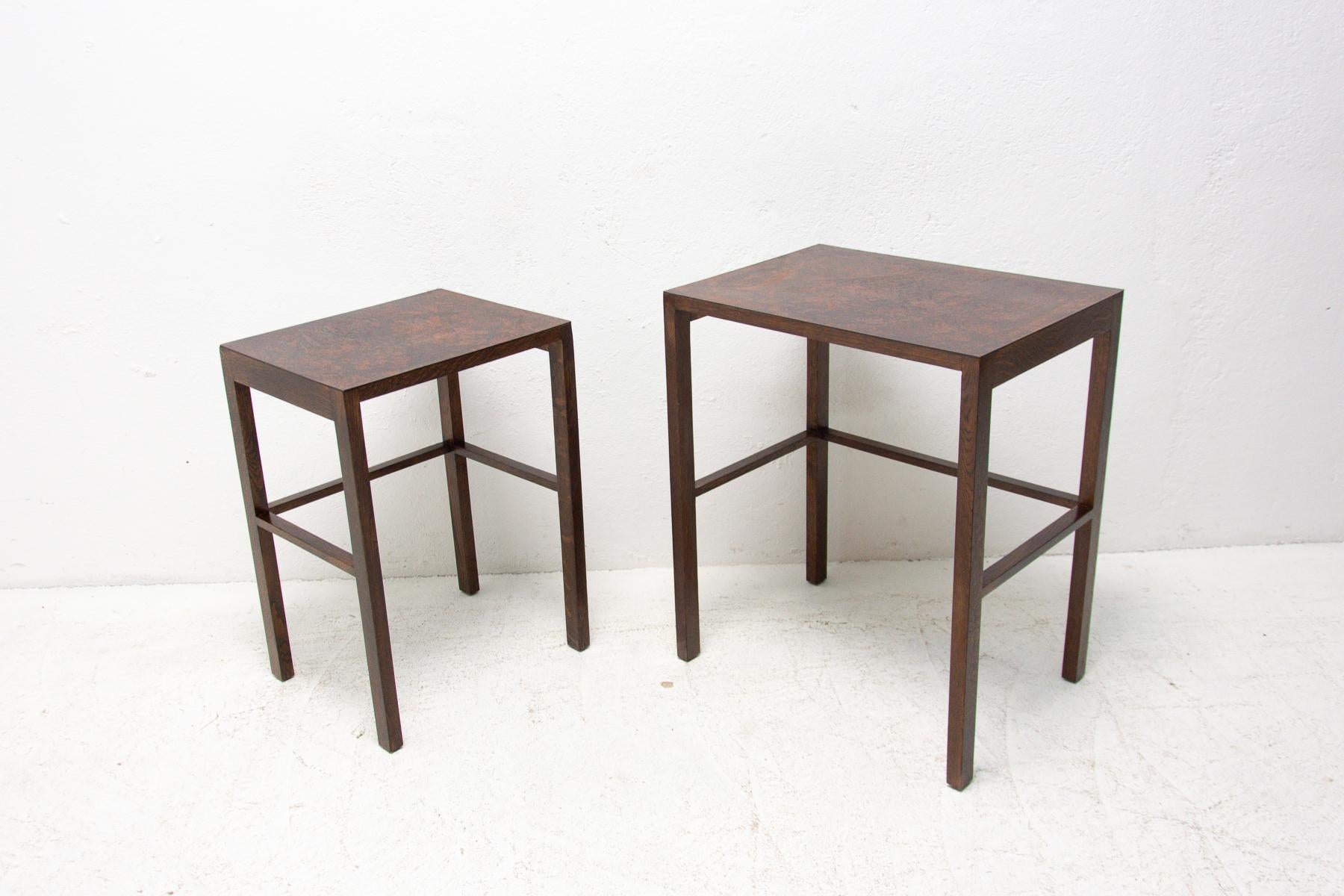 Jindrich Halabala, two tables from the famous set of three nesting tables catalogue no. H-50, designed in the 1930s and produced in the 1950s. It´s made of stained beech wood and it features a dark bakelite top. It is in good vintage condition,