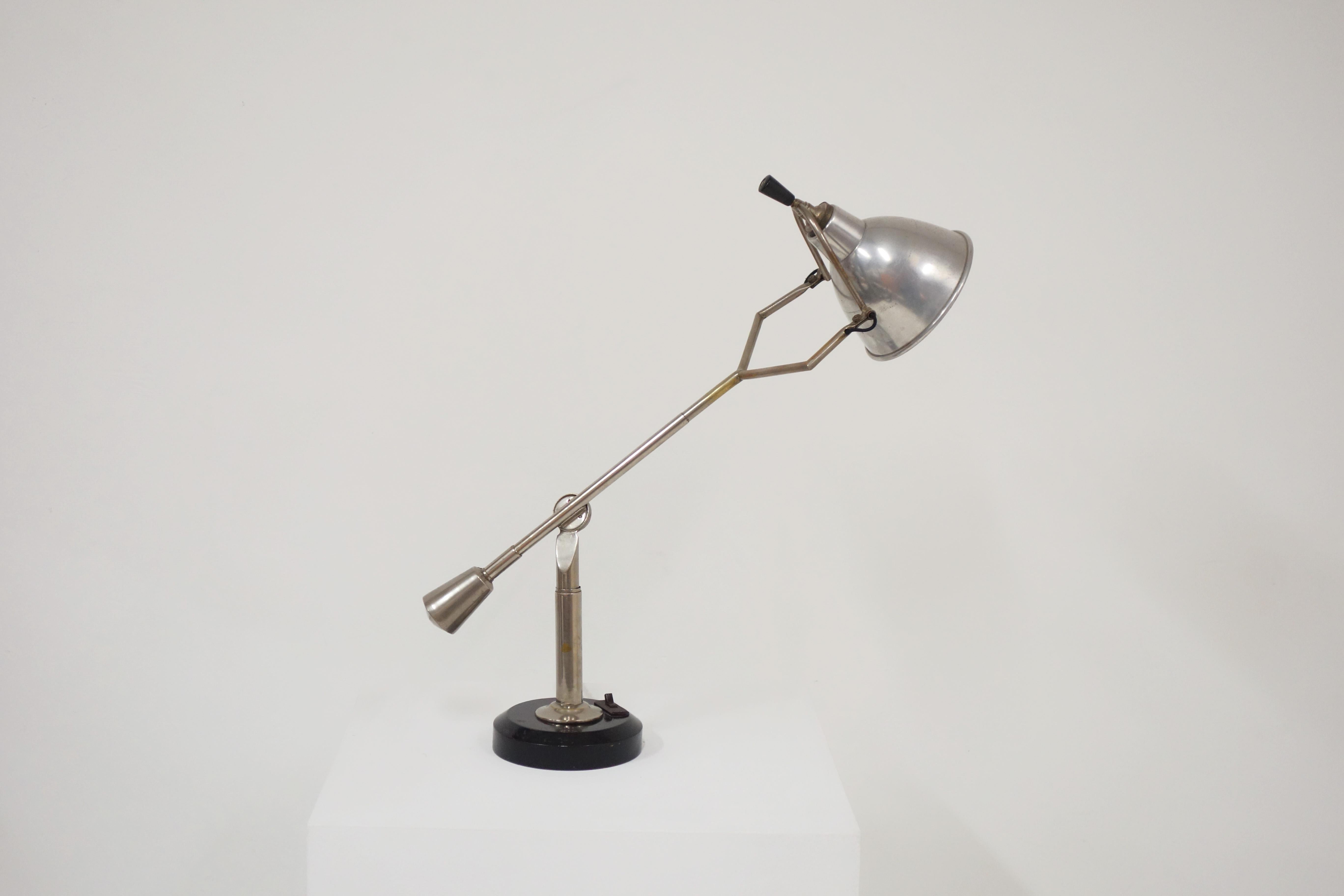 Original and vintage modernist nickel-plated counterbalance lamp by Eduard-Wilfrid Buquet, circa 1925. 
The circular base is made of lacquered wood. Original bakelite switch on the base. 
Nickel-plated for the lamp. You can easily choose the