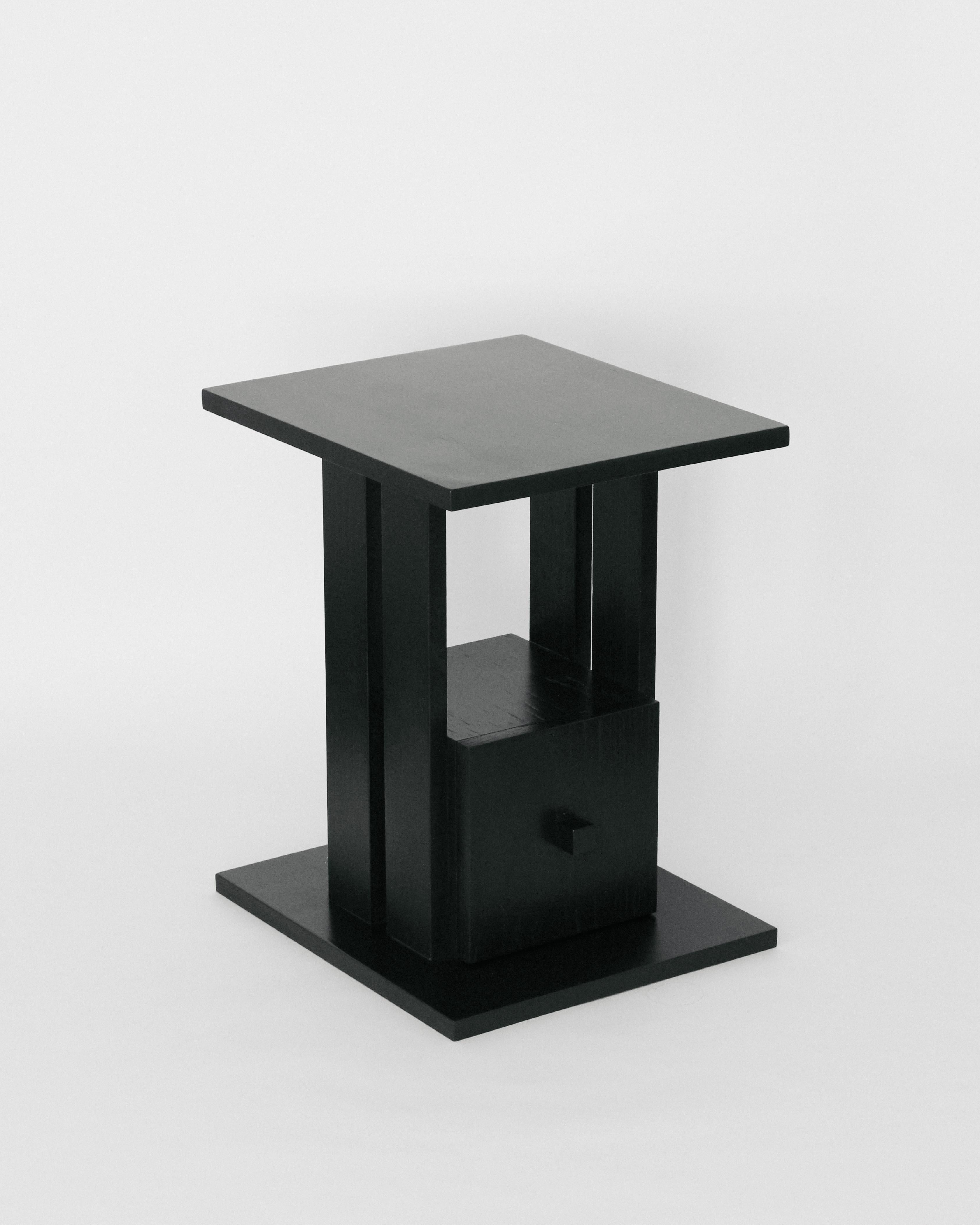Modernist side table handmade in Oak with a black lacquer finish. Made in Los Angeles by expert craftsmen, and designed by Christian Sanchez. 

This table draws inspiration from modernist furniture of the 1950's, and is defined by it's clean lines