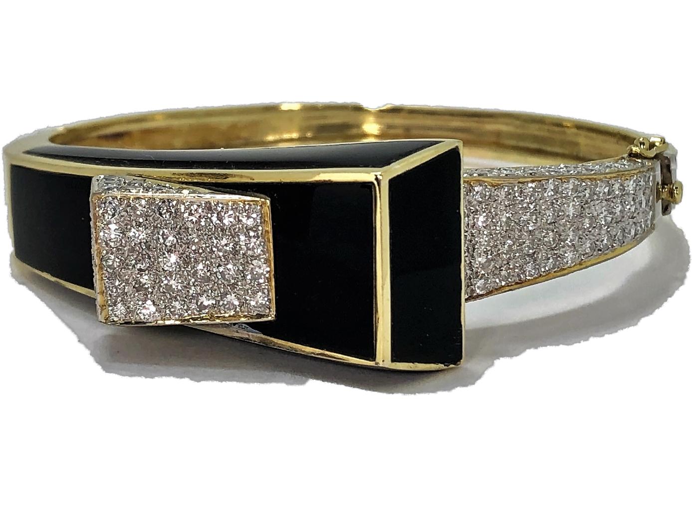 Fabulous Modernist bangle made of 18K Yellow Gold inset with five custom cut onyx panels, and with 154 round brilliant cut diamonds weighing an approximate total of 4.25CT of overall G/H Color and VS2 Clarity. This unique cuff fits a medium to large