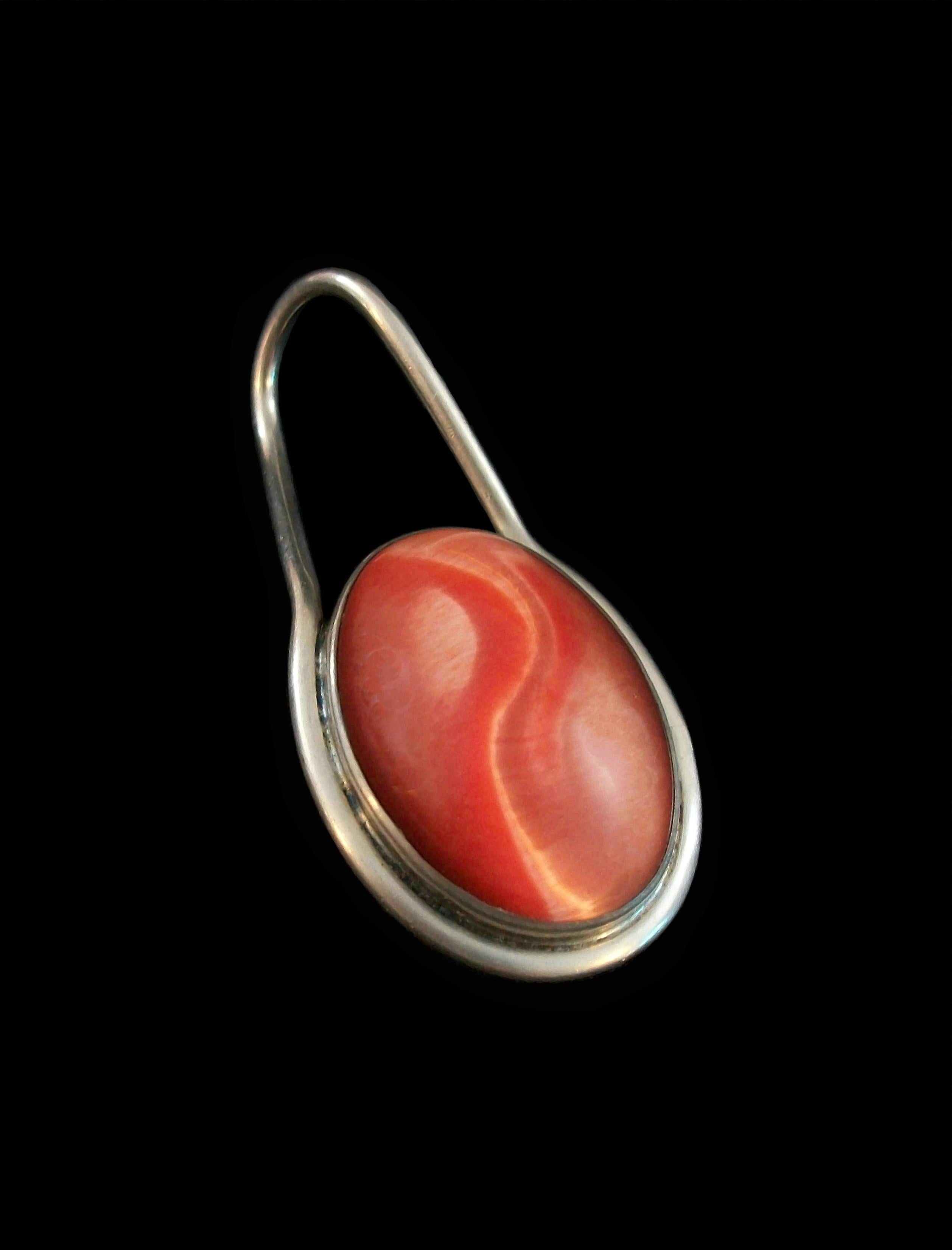 Modernist orange swirl glass and sterling silver unisex pendant - featuring a large polished bezel set cabochon - large bale - no chain - signed on the back TB-95 - Mexico (Taxco) - late 20th century.

Excellent vintage condition - all original -