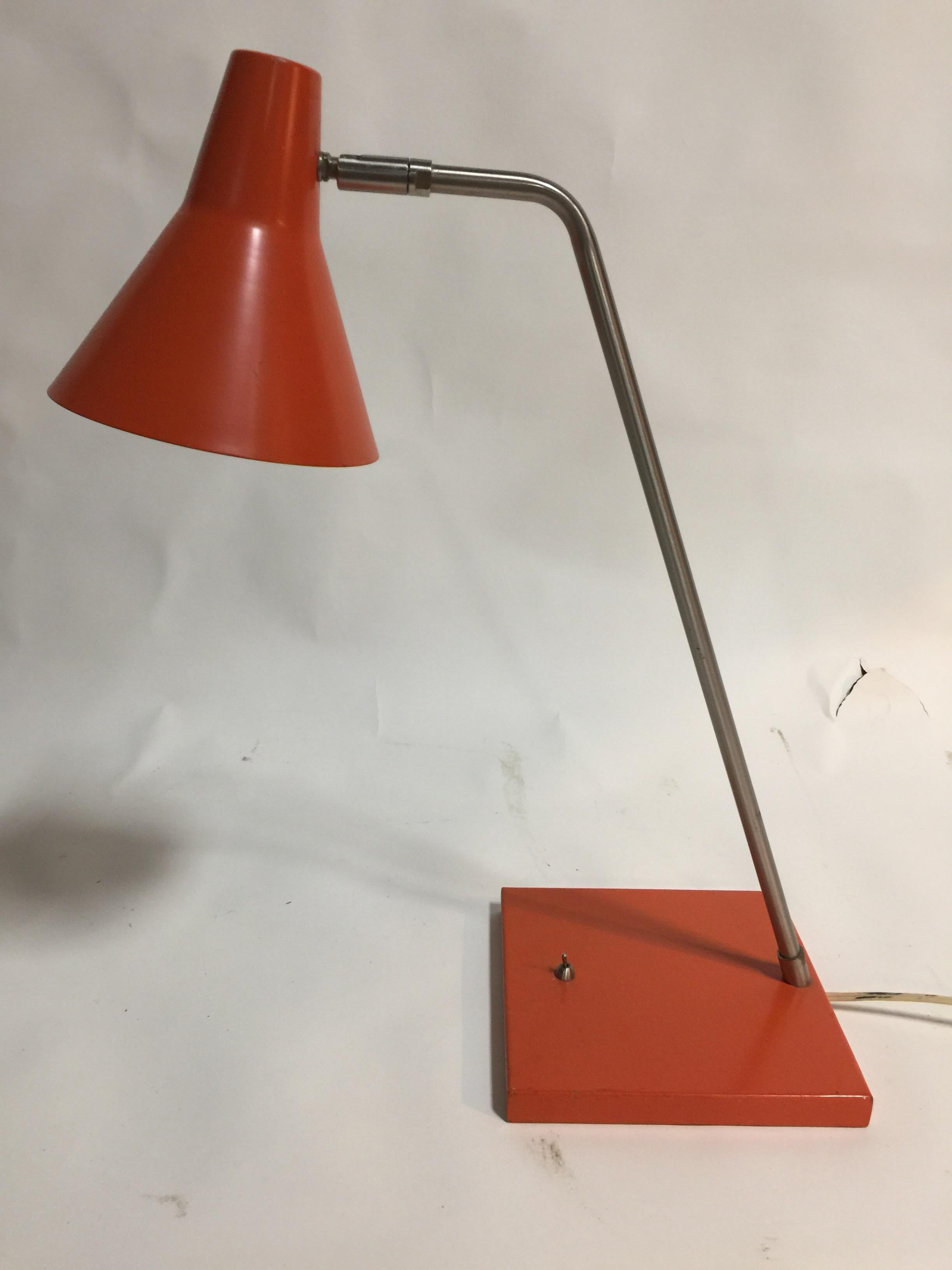 A contemporary orange metal desk lamp. Features a movable chrome arm with orange shade and base. Imported, circa 2000.

Dimensions: 21 inches H x 8 inch base diameter x 6.5 inch shade W.
   