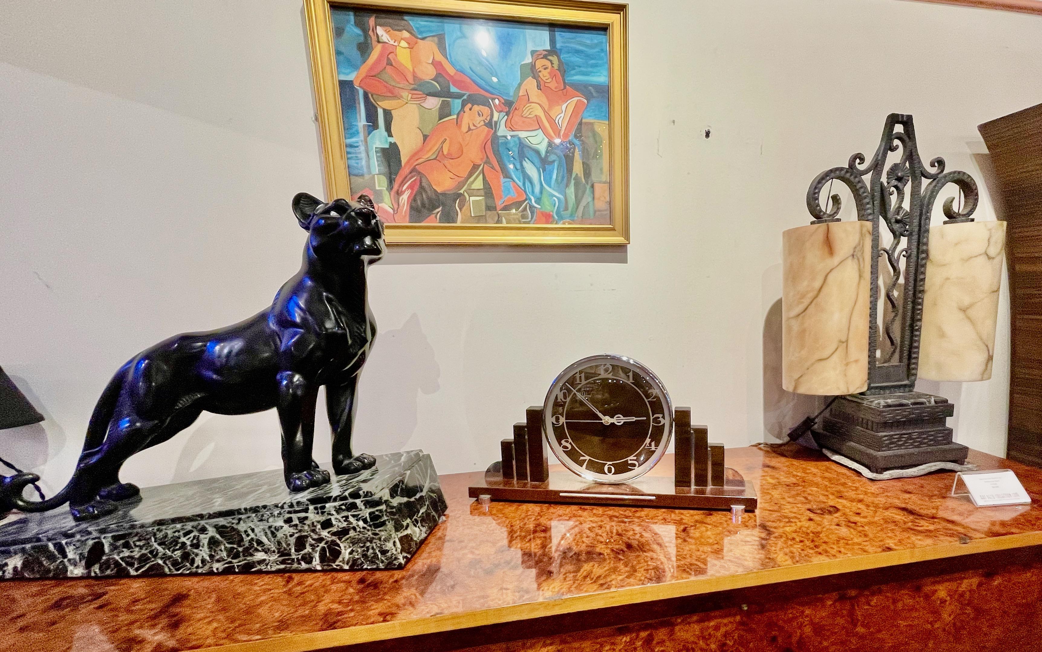 Modernist Original Art Deco Mantle Clock Quartz Conversion. Great looking clock with original deco numbers and hands. Nice metal details on the stepped outside vertical design as well as the front 1/4 round feet. Dark stained walnut wood. with