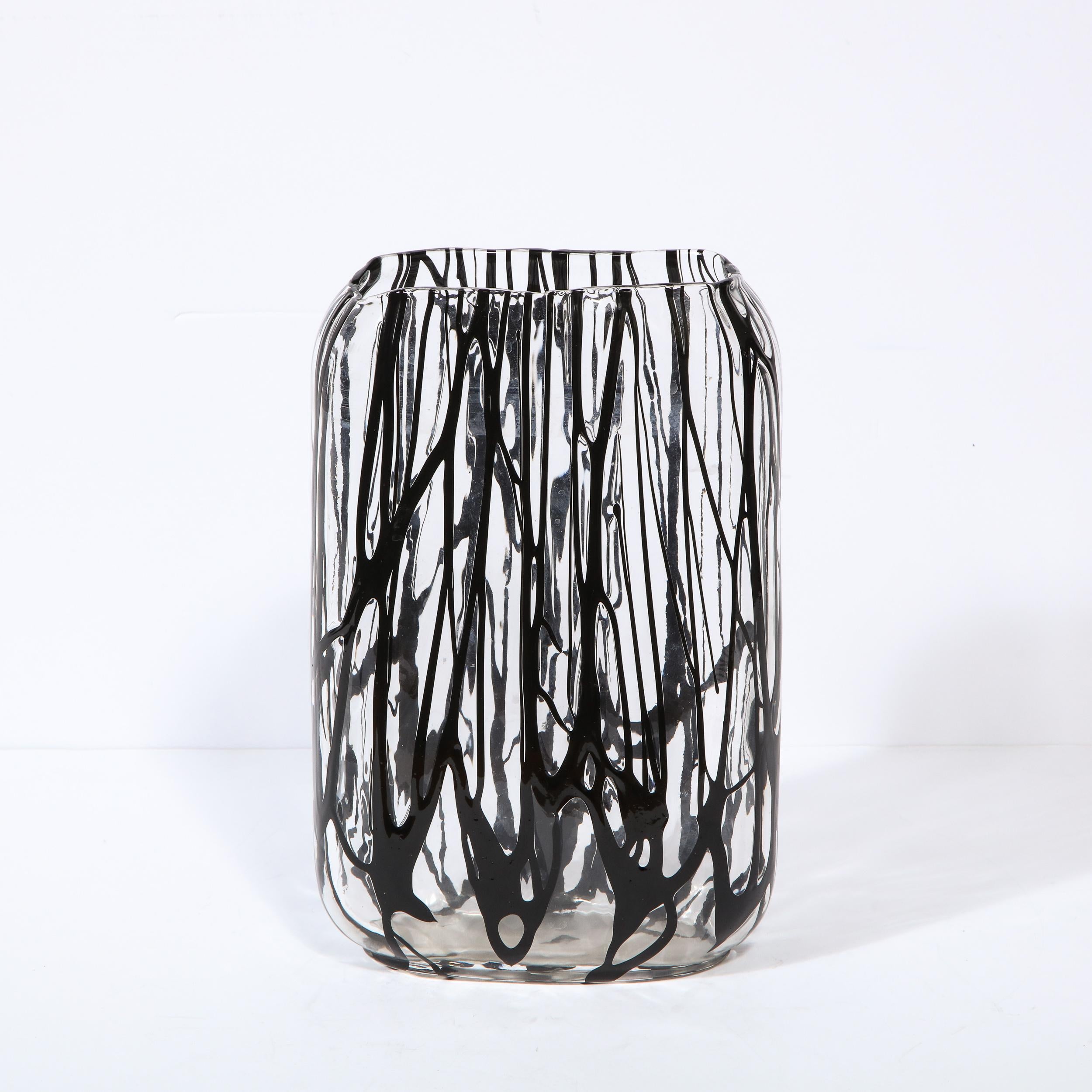 This elegant modernist vase was realized in Murano, Italy- the island off the coast of Venice, renowned for centuries for its superlative glass production. It features an oval body in translucent Murano glass with black expressionistic detailing