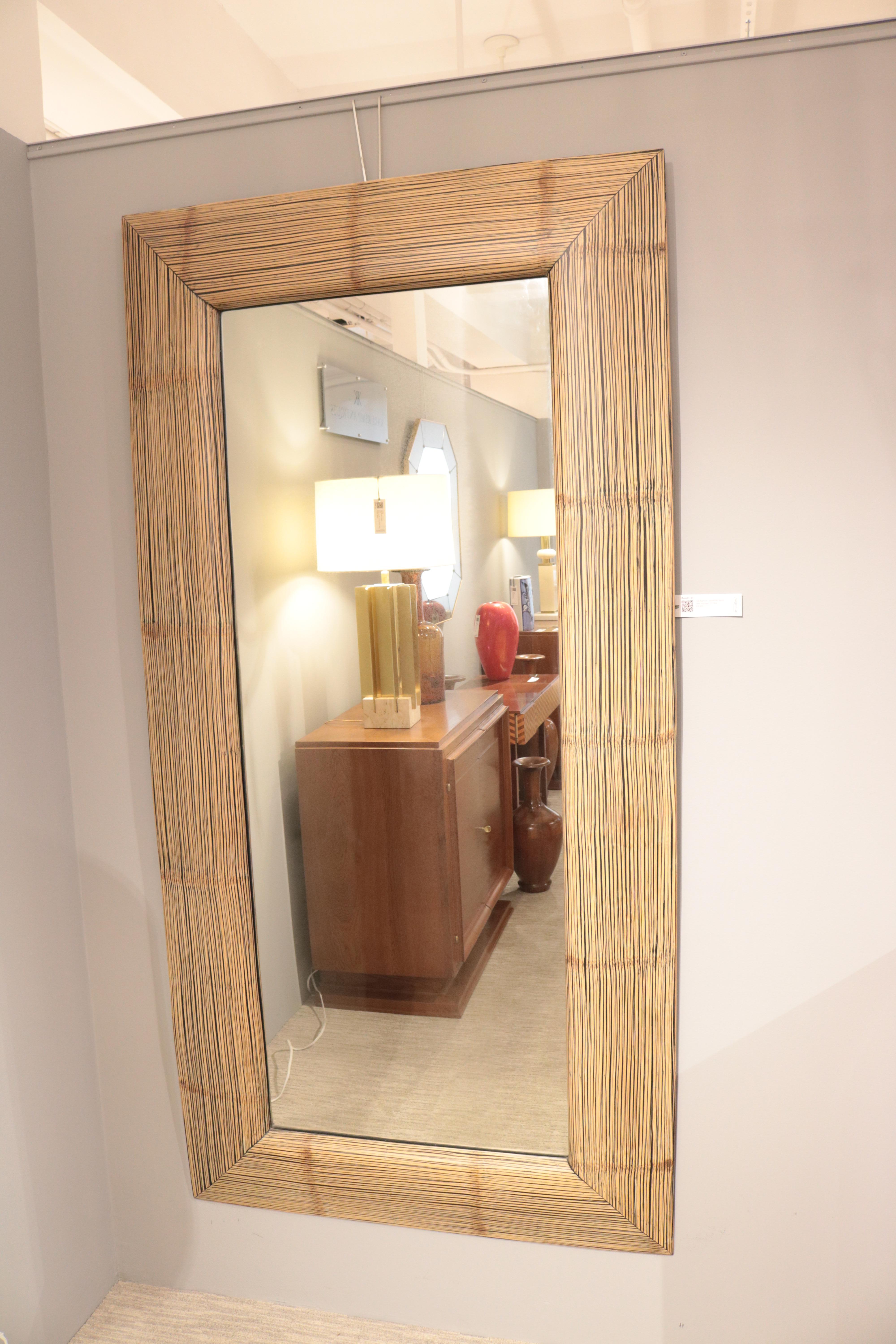 A tall modernist oversized wall mirror.
Faux bamboo.