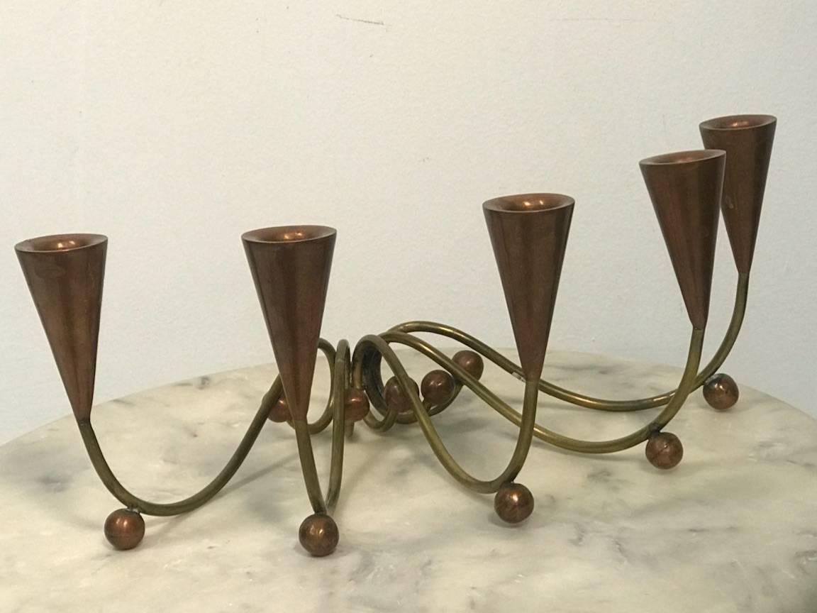 Great decorative pair of midcentury scrolling brass and copper candle cup and copper ball feet candelabra in the style of Los Castillos. Each candelabra has five candleholders.