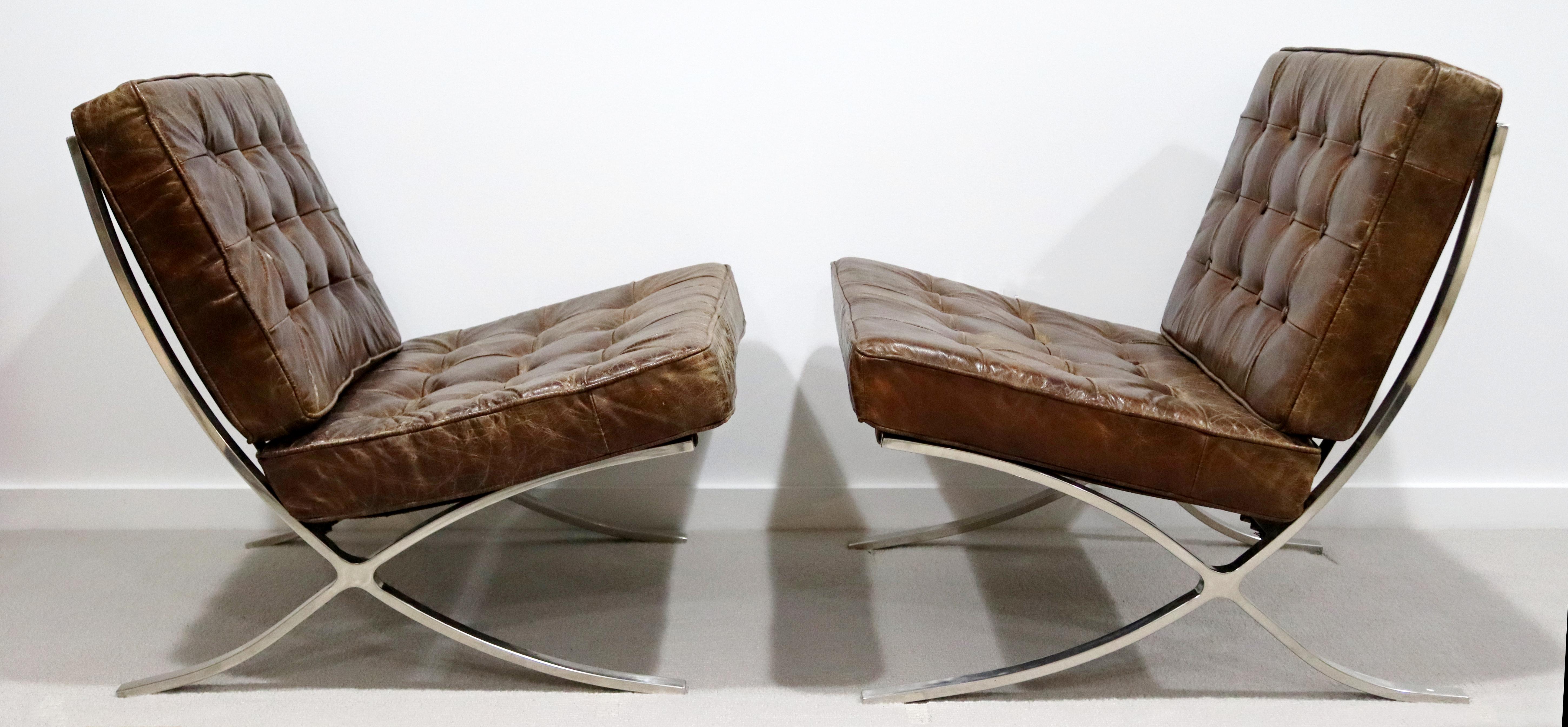 For your consideration is a magnificent pair of Barcelona style lounge chairs, with brown leather seats on chrome bases. With the perfect vintage patina. Purchased in 1980. The dimensions are 31.5