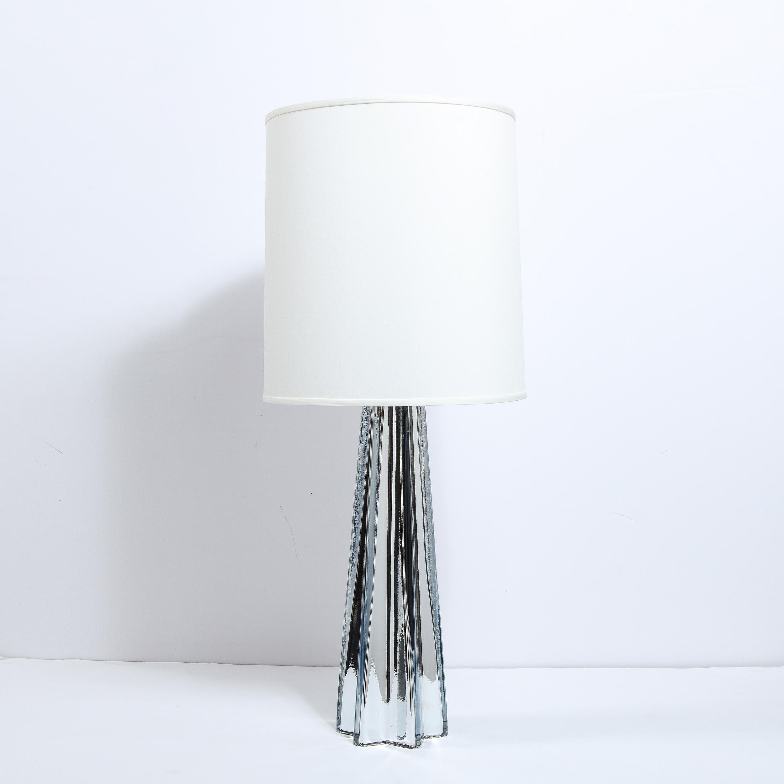 This elegant pair of table lamps were hand blown in Murano, Italy- the island off the coast of Venice renowned for centuries for its superlative glass production. They feature tapered stylized x-form bodies with subtly concave sides that connect the