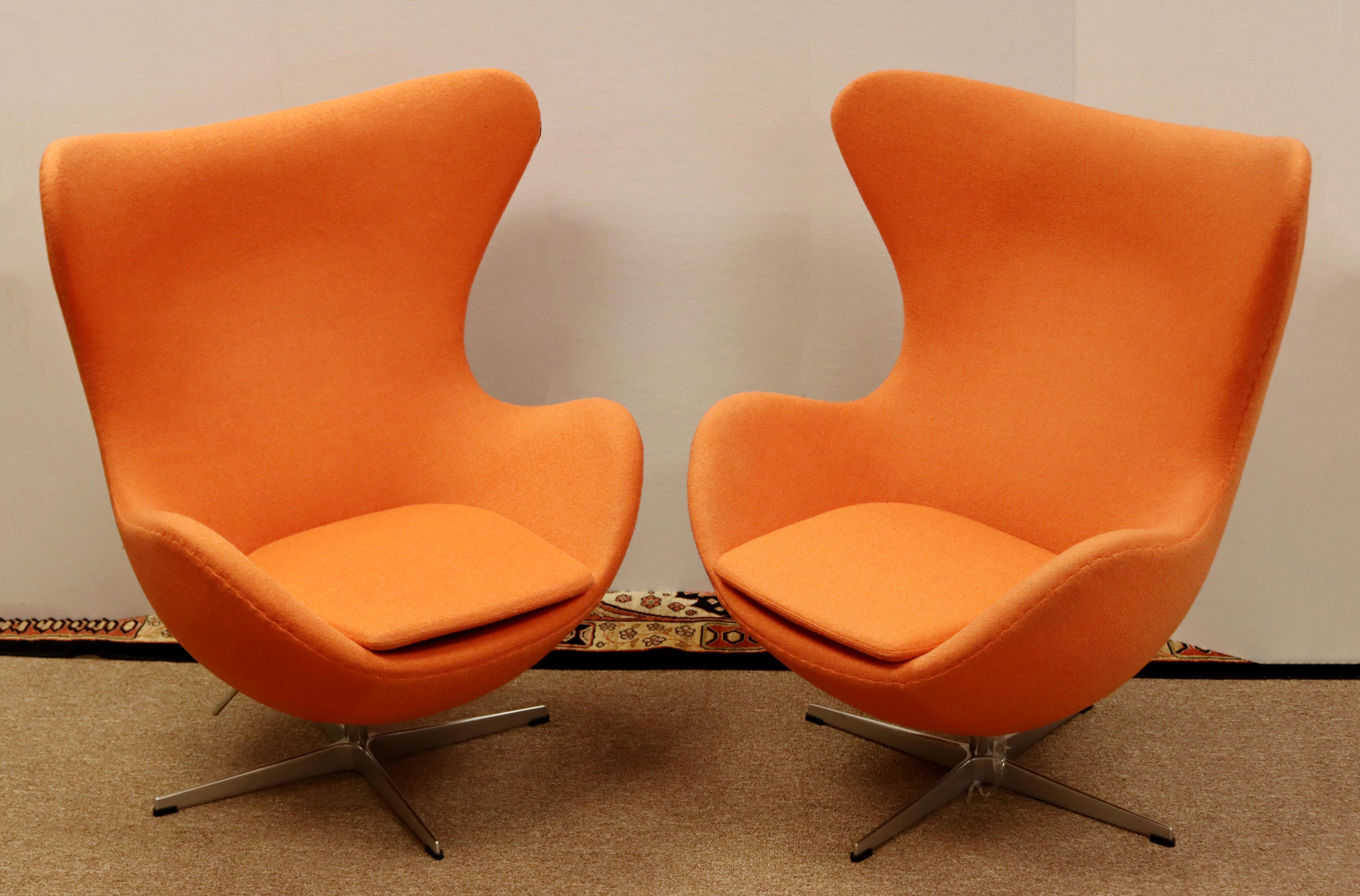 For your consideration is a stupendous pair of high back Egg chairs, in the style of Fritz Hansen, by Rove. In excellent condition. The dimensions are 34.5