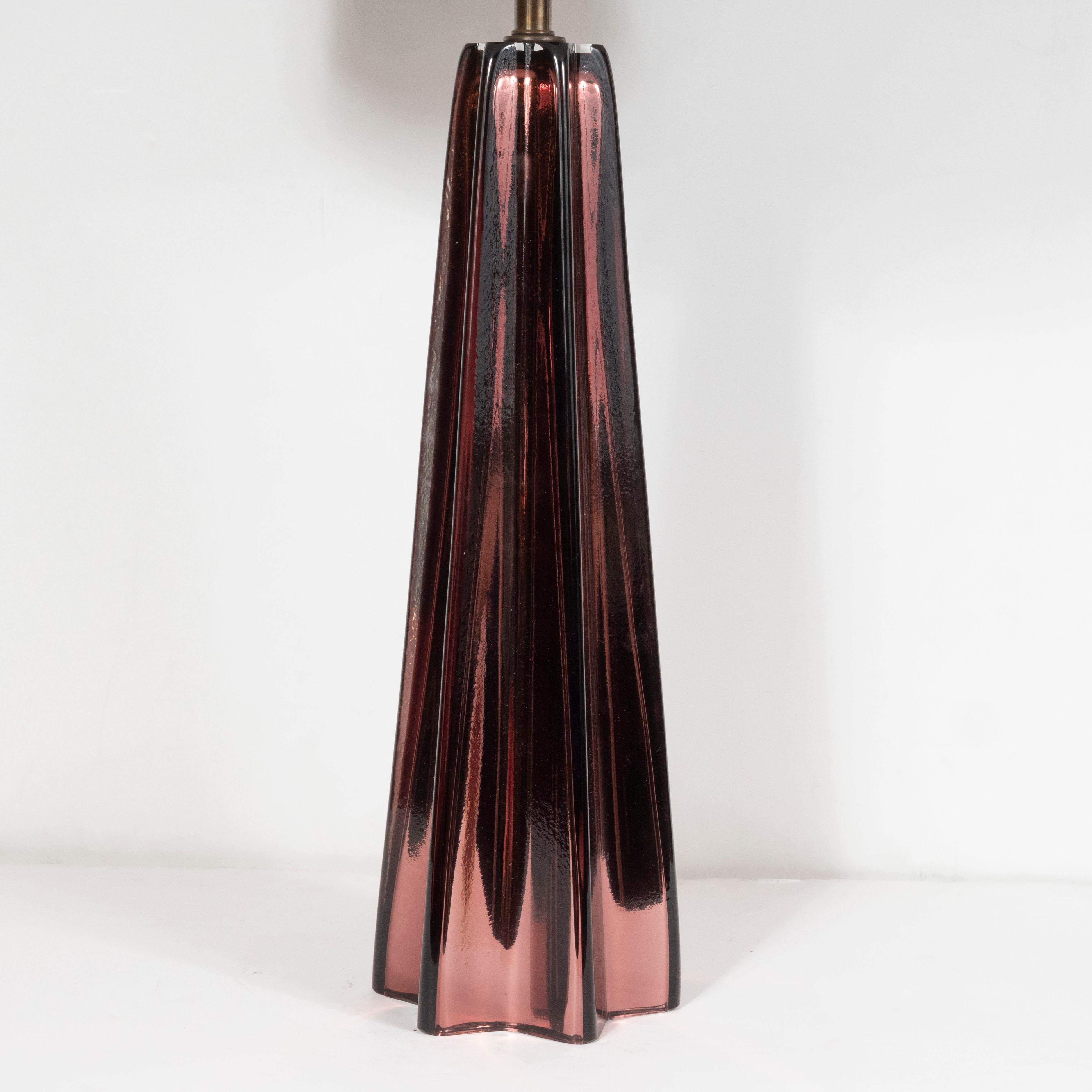 This elegant pair of table lamps were hand blown in Murano, Italy- the island off the coast of Venice renowned for centuries for its superlative glass production. They feature tapered stylized X-form bodies with subtly concave sides that connect the