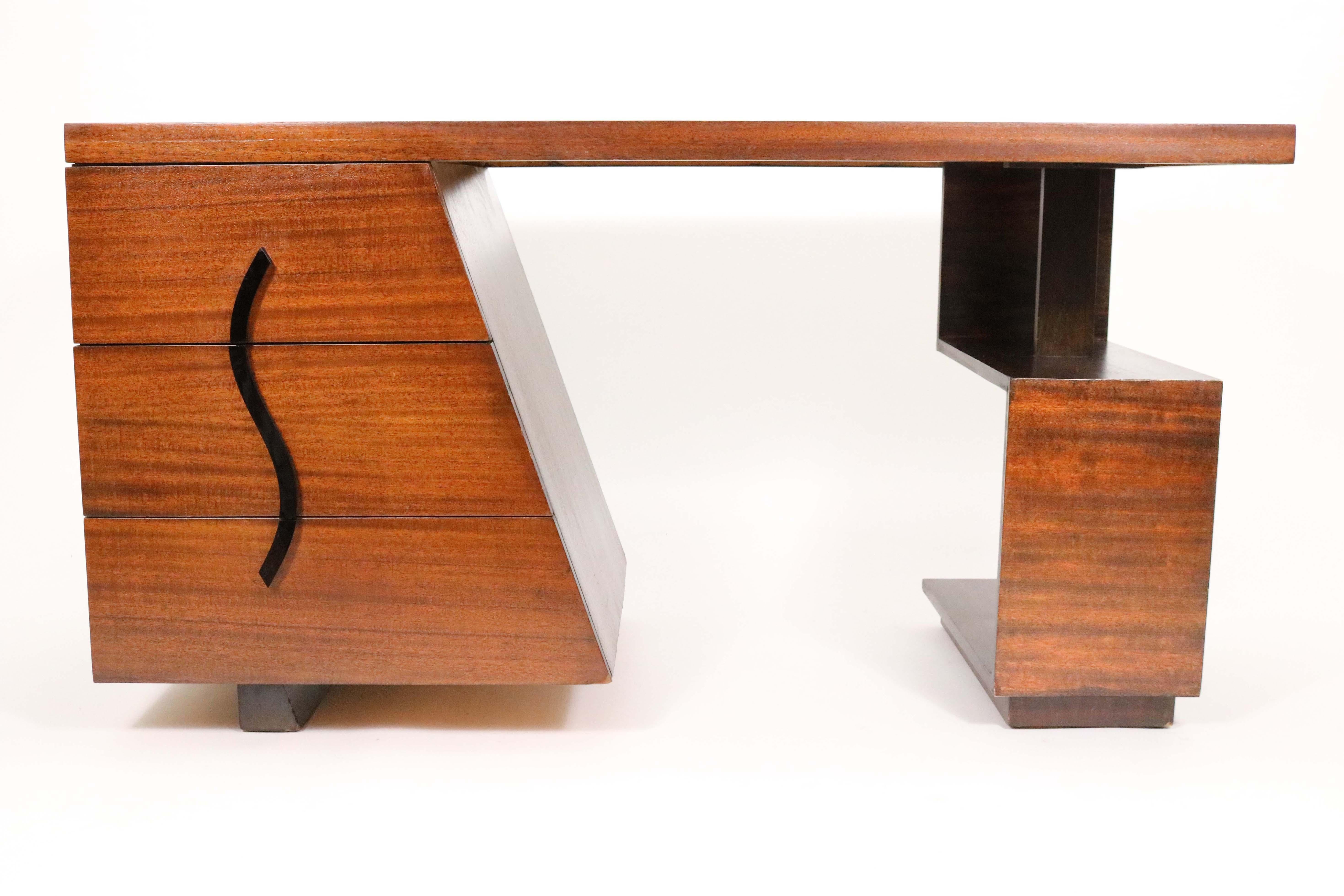 Incredible modernist art deco partners desk geometrically and sculpturally configured art form. The piece retains its original brass tag inside the drawer signed Maximillian for Karp Furniture, Los Angeles. Karp furniture produced some interesting