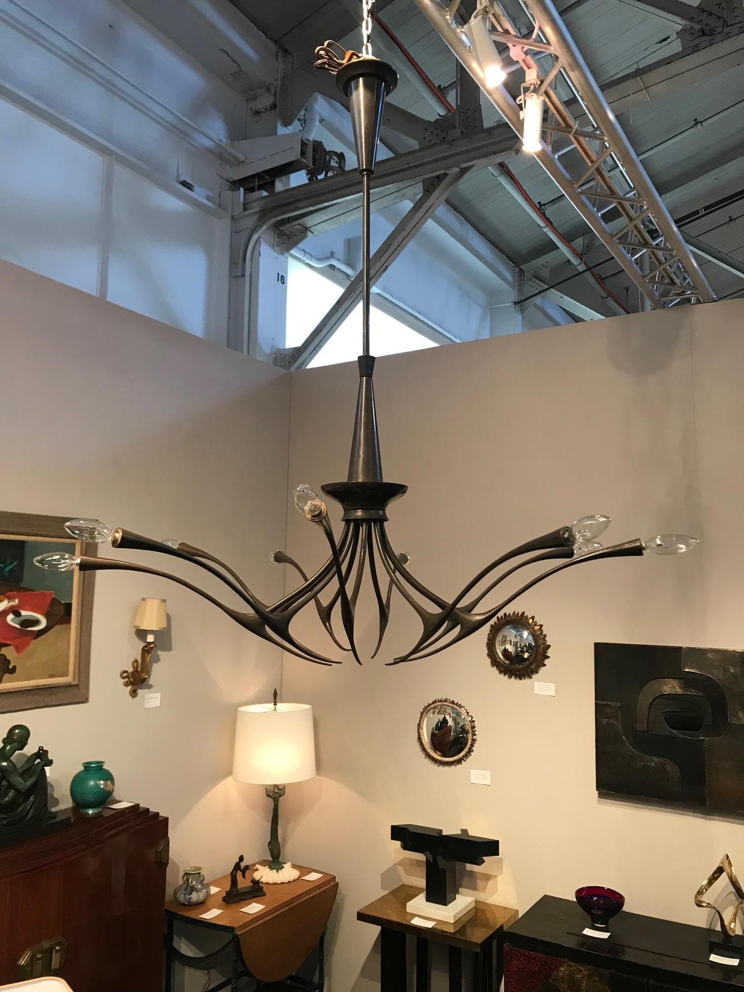 Modernist patinated brass chandelier by Oscar Torlasco model 392.
Measures: H 45, D 35.5 in.

 $14,500.
  