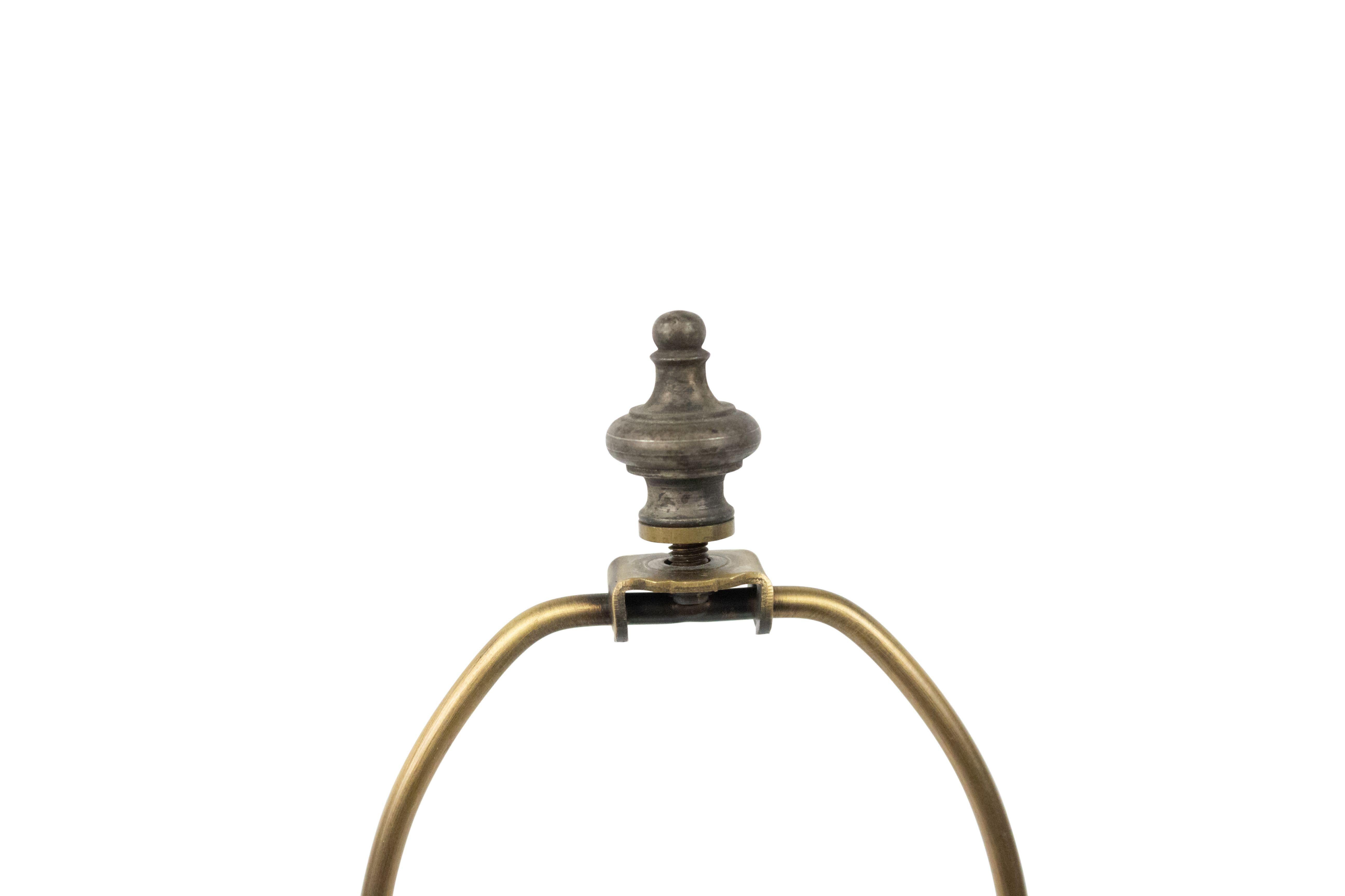 Contemporary patinated brushed metal table lamp with cylindrical body and brass accents.