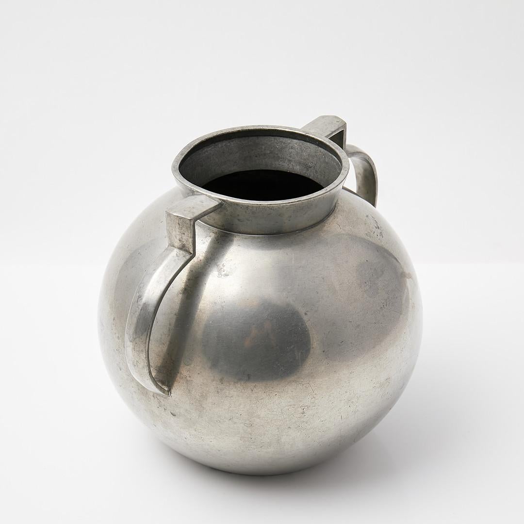 This exceptional pewter vase is a rare and highly collectible work by Folke Arström, one of Sweden’s most influential 20th-century designers. Created 1931 (E8) for the prestigious Guldsmedsaktiebolaget (GAB), this piece exemplifies the streamlined