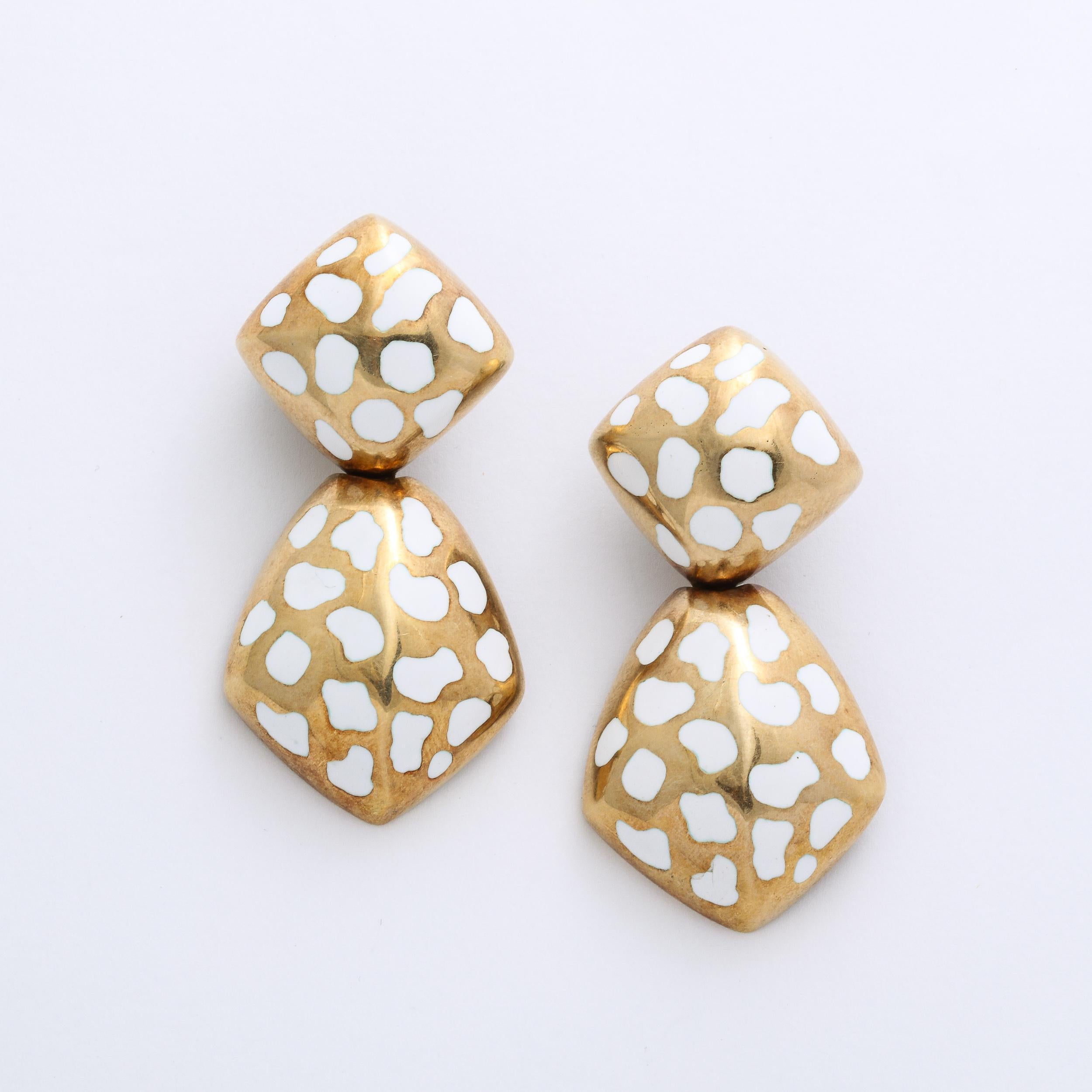 These bold pierced earrings are 14 yellow gold and are set with white enamel geometric and organic detailing. These are beautifully made and also can be converted to pierced if the owner wishes. Excellent vintage condition .

American circa