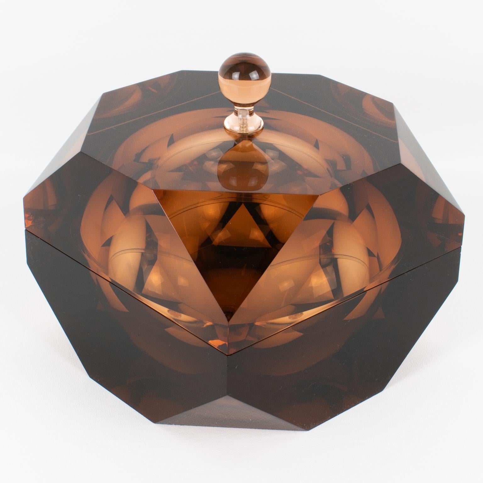 This exceptional geometric Lucite or acrylic decorative lidded box was designed in Italy. The piece was crafted circa 1960. It features a modernist shape with an incredible carved prismatic form. The box is made of extra-thick Lucite or Plexiglass