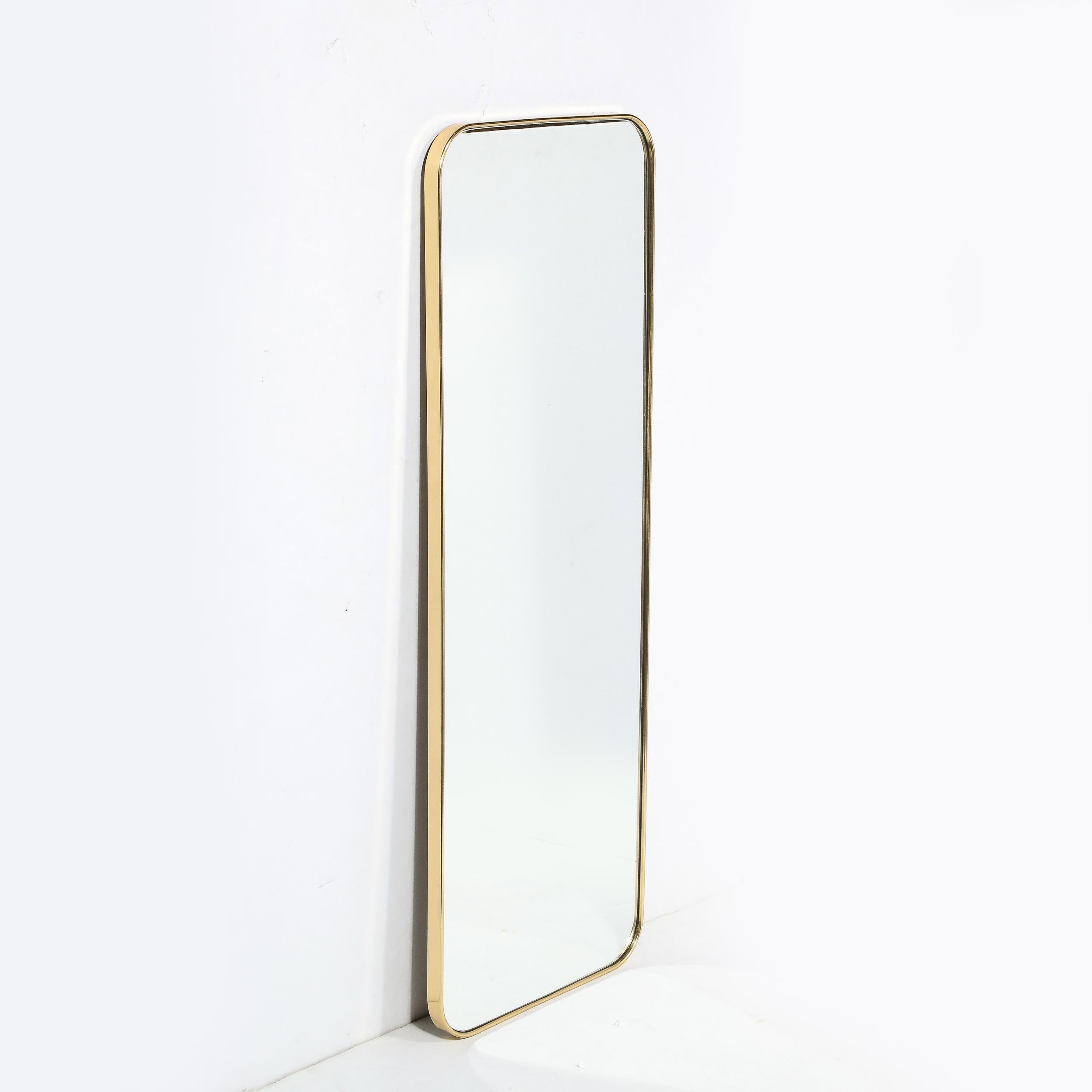 This stunning and graphic modernist mirror was newly realized in the United States exclusively for High Style Deco. Inspired by Classic Mid Century Italian Mirrors of the 1950s, this piece offers a rectangular form with rounded corners wrapped in