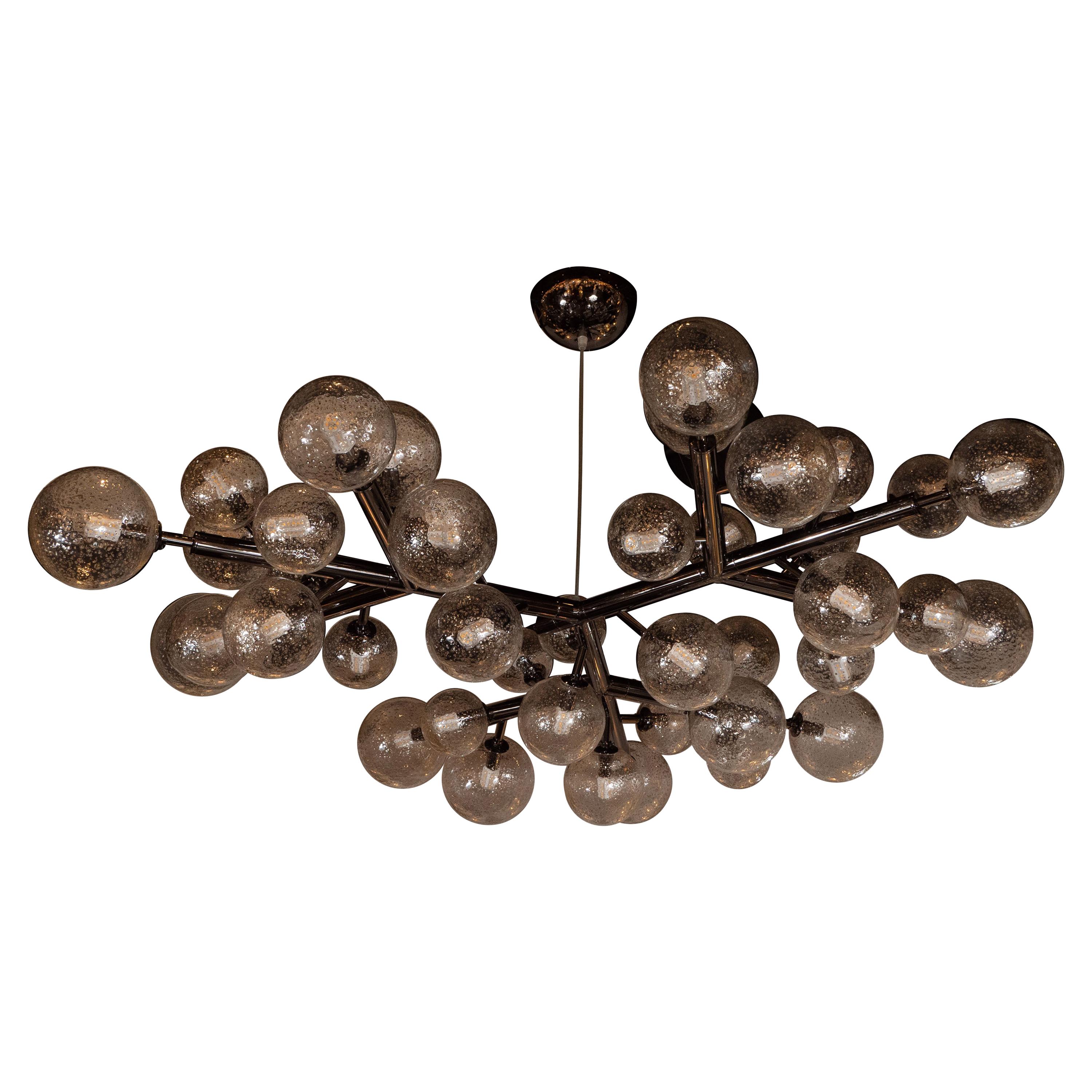 This stunning and dramatic polished gunmetal and hand blown Murano glass molecular 