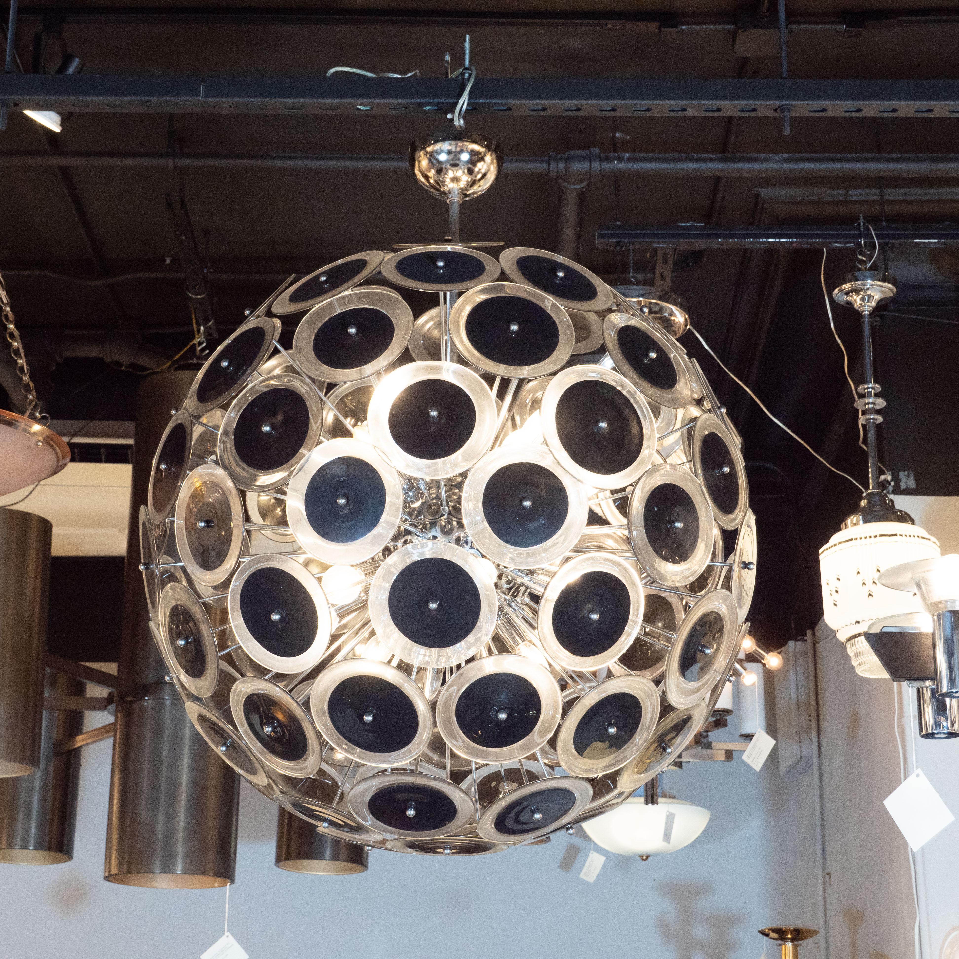 This dramatic and graphic Vistosi sputnik chandelier was hand blown in Murano, Italy, the islands off the coast of Venice renowned for centuries for their superlative glass production. It features a wealth of polished chrome emanating from circular
