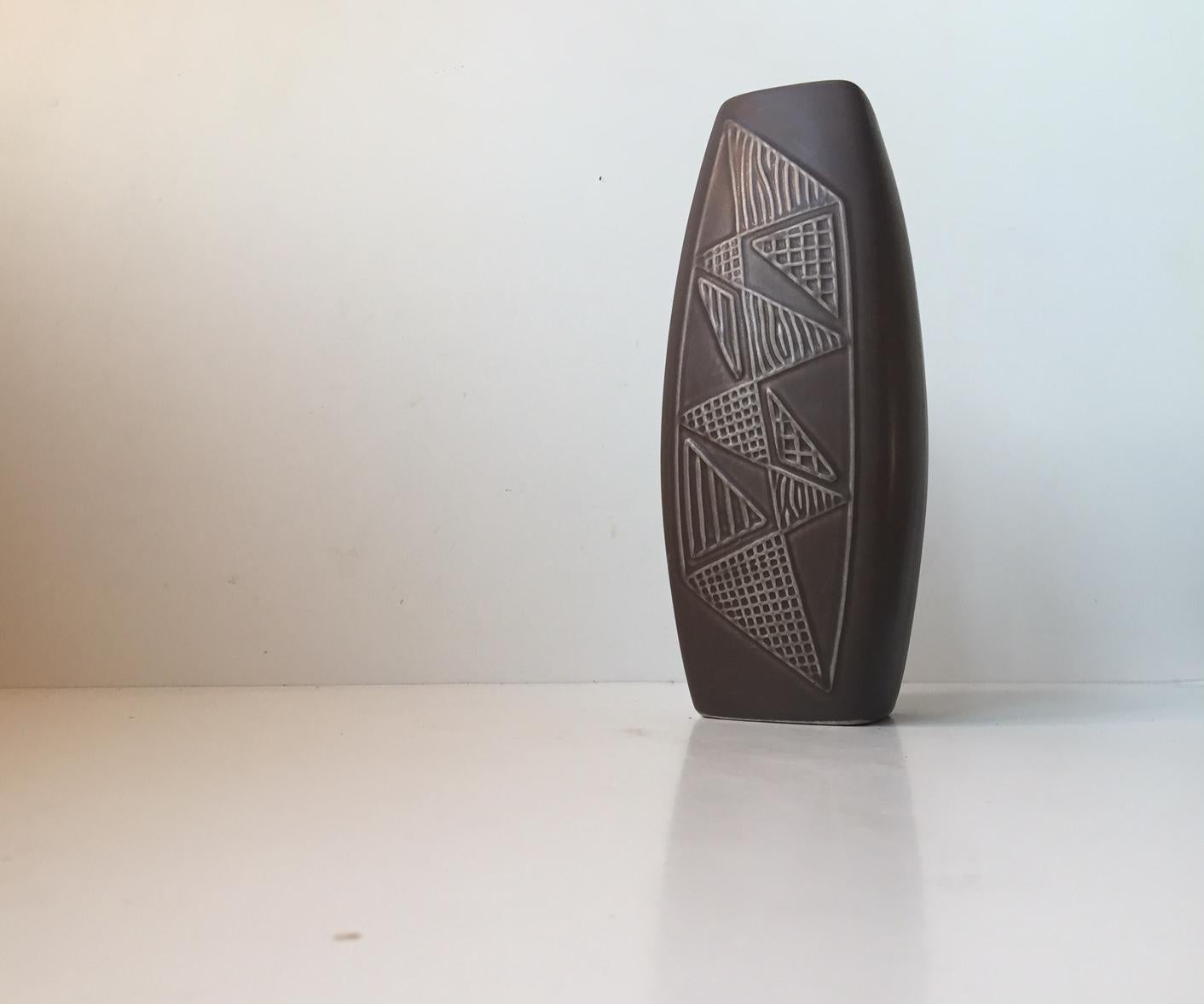 - Large ceramic relief vase.
- Designed by Svend Aage Holm-Sorensen
- Slate grey main glaze with geometric decor in relief
- Manufactured by Søholm in Denmark from 1956
- Nice intact vintage condition only with usual scratches beneath the