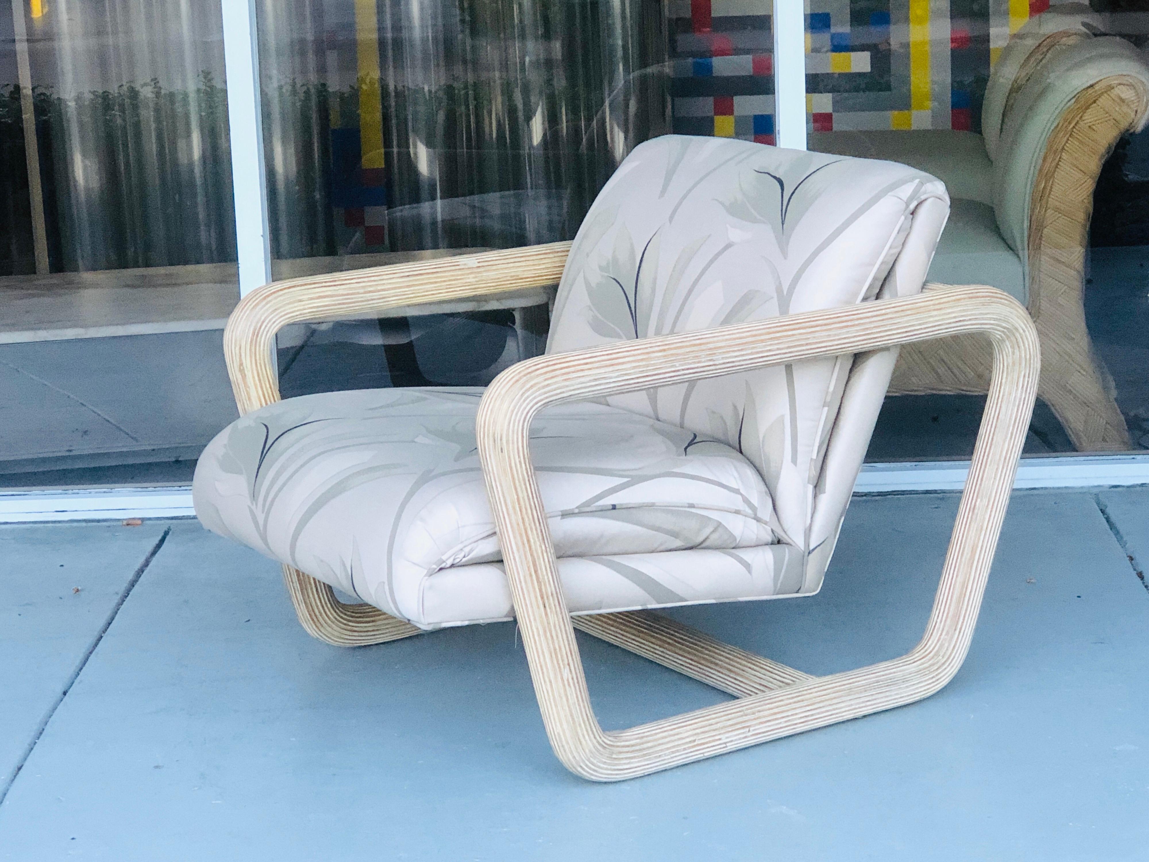 A beautiful 1980s modernist lounge chair. The aerodynamic frame is covered in pencil reed. Tropical modernism at its best.