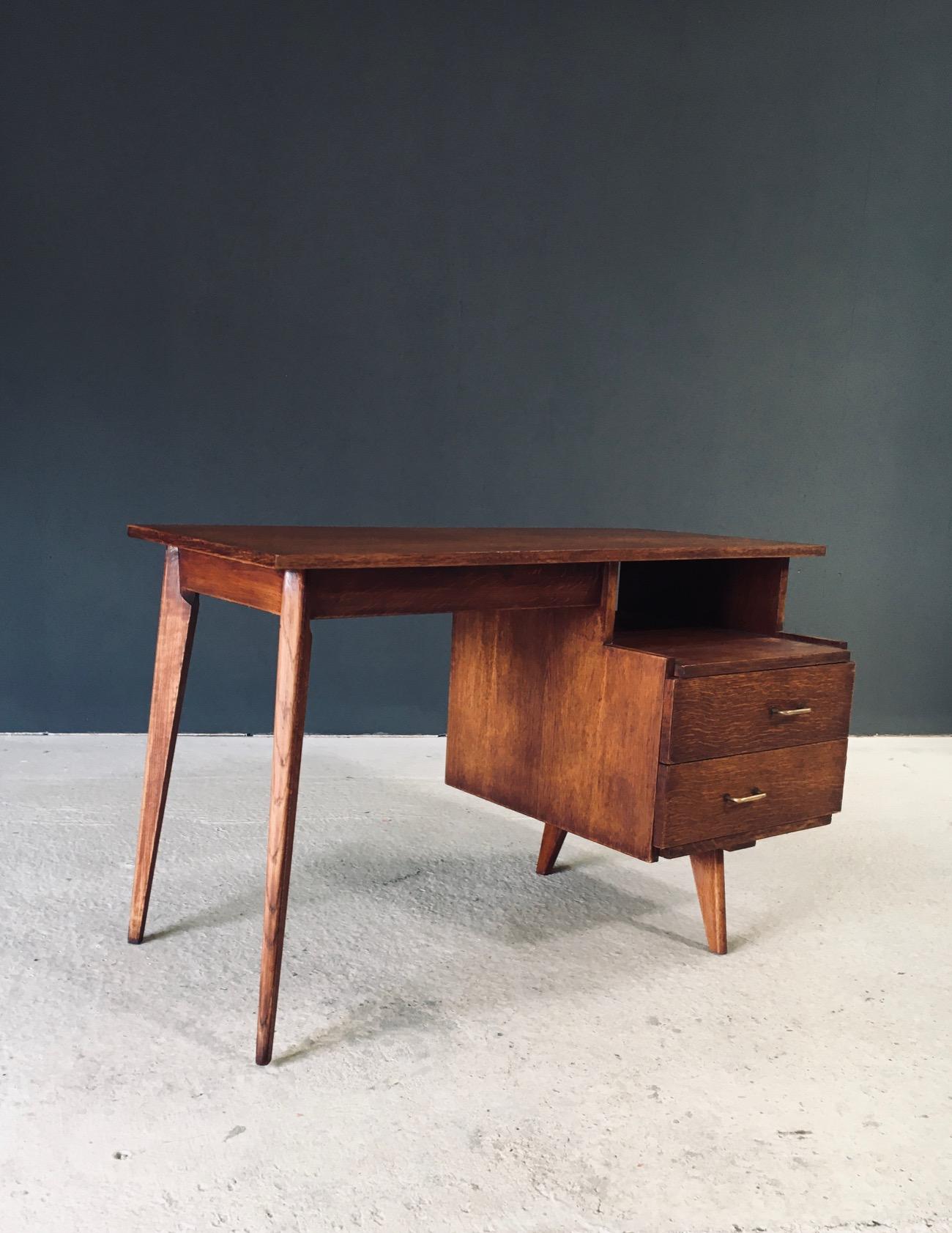 Vintage Midcentury Modern Modernist Reconstruction Period Design Writing Desk. Made in France, early 1950's period. Solid oak constructed desk with two drawers and slender tapered legs. Beautiful in it's simplicity and details on this well designed