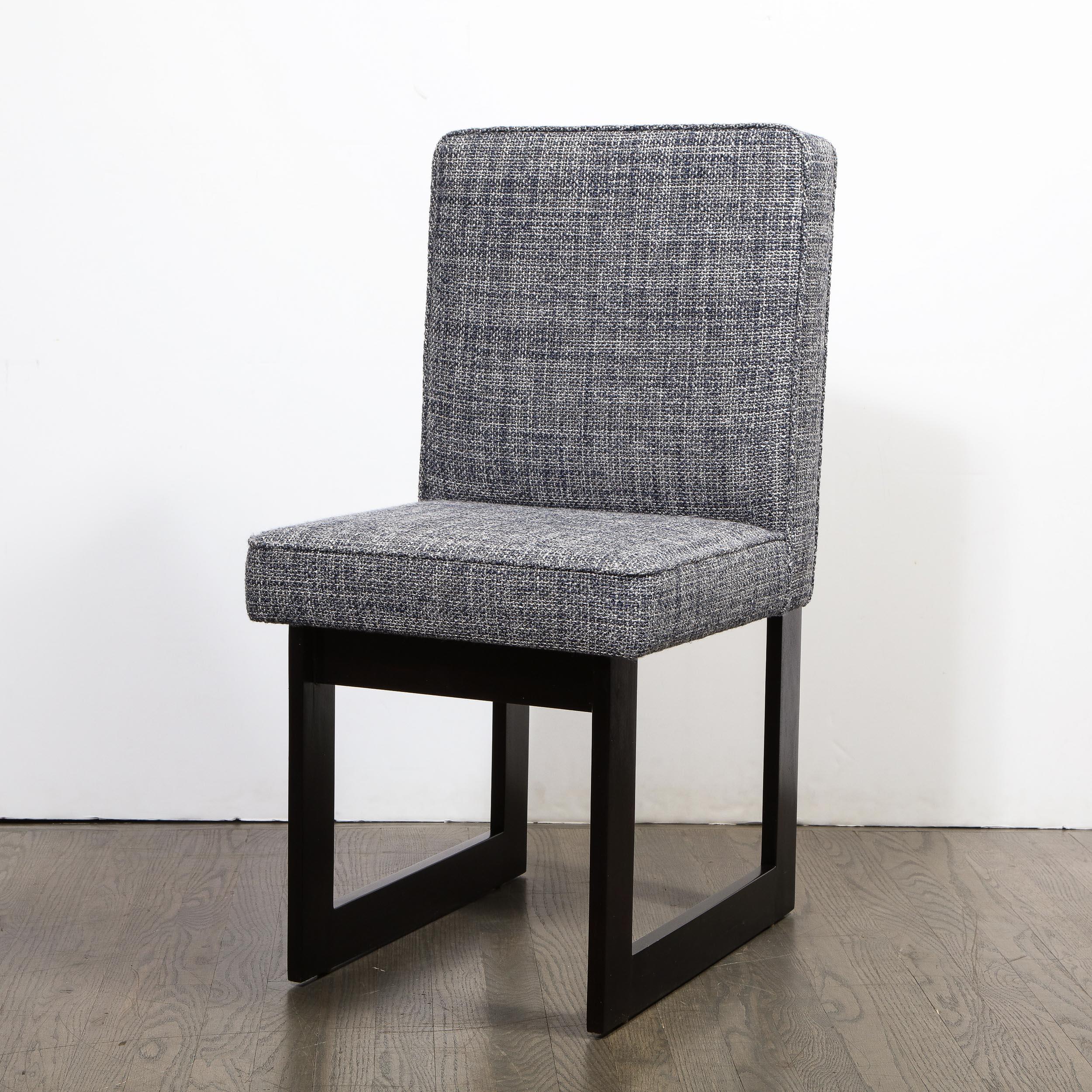 This refined modernist side chair offers a graphic open form geometric ebonized walnut frame in ebonized walnut. The ebonized sides of the chair appear as open squares, while the frame fastens to the back of the seat creating a rectangular form. The