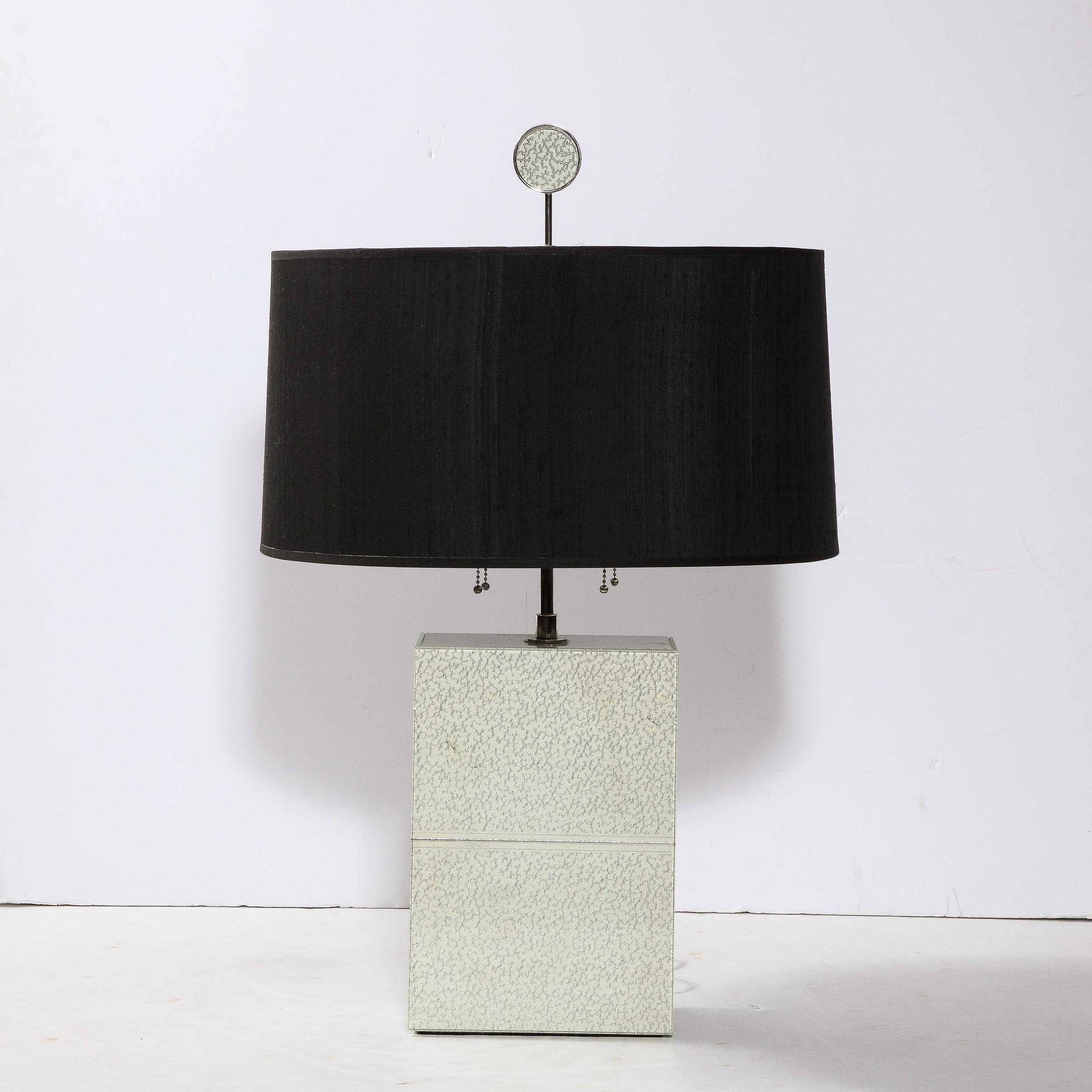 This beautiful modernist table lamp was realized by the celebrated contemporary designer Robert Rida in Italy circa 2000. The piece features a volumetric rectilinear form in frosted glass that offers beautiful inflections of acquamarine and a
