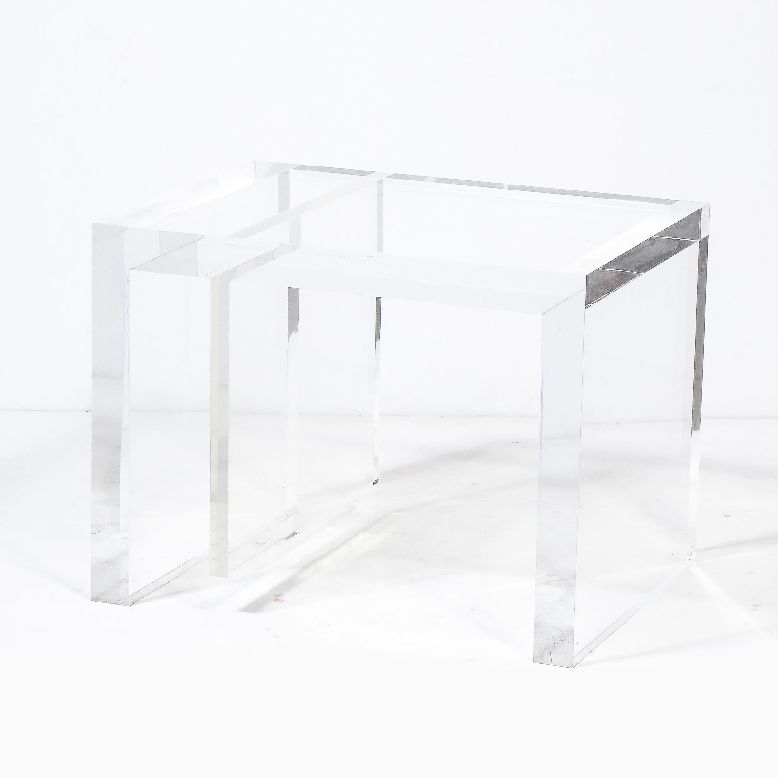 This sophisticated modernist side/ occasional table was realized in the United States during the latter half of the 20th century. It features a rectilinear and graphic body composed of beautiful translucent lucite. With its dynamic geometry and