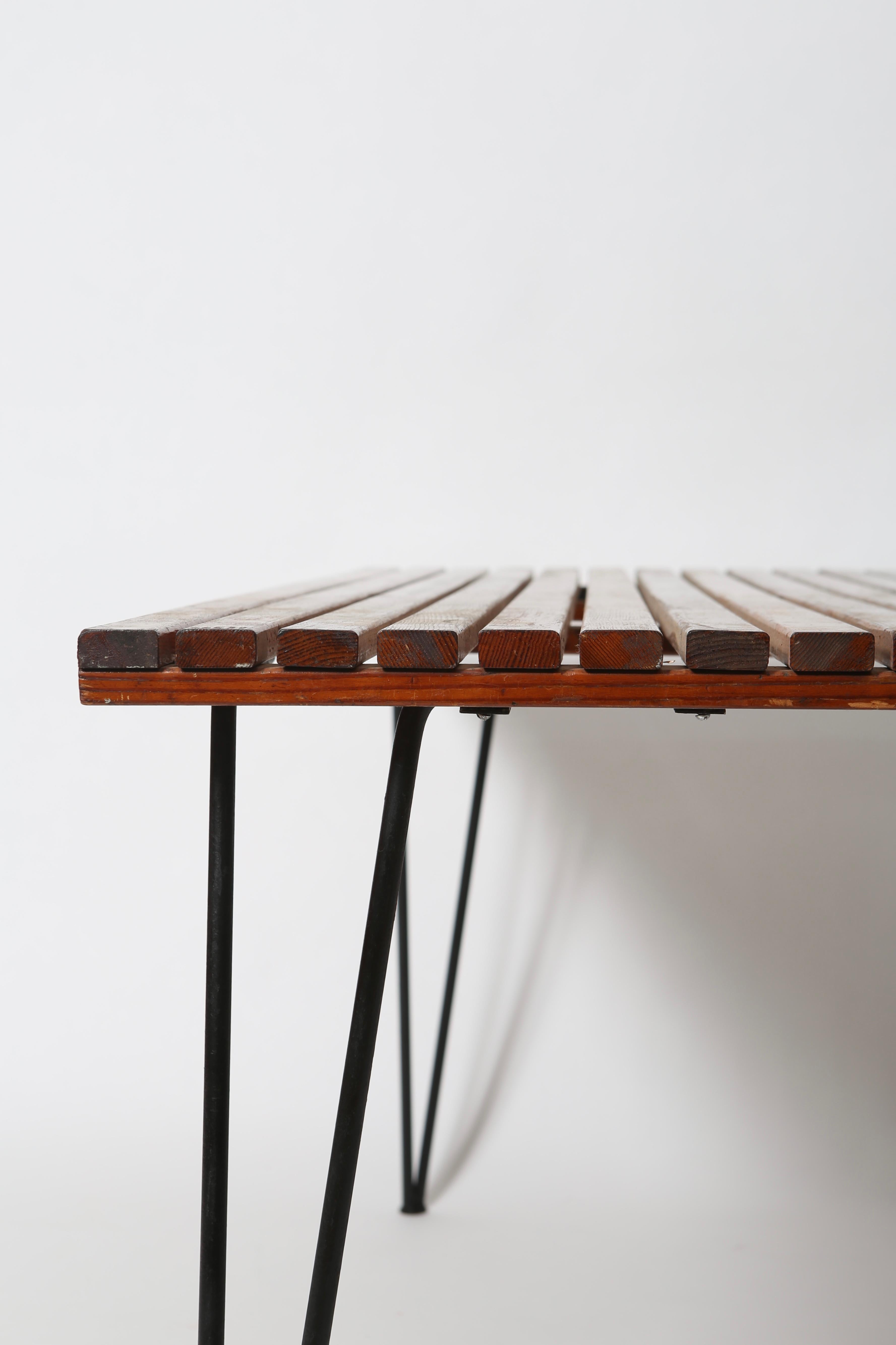 Designed by Pipsan Saarinen-Swanson for Ficks Reed in 1949. The slatted top is made from redwood and the hairpin legs make it iconic. Modernist outdoor living at its best; although we feel this table would work very well indoors paired with