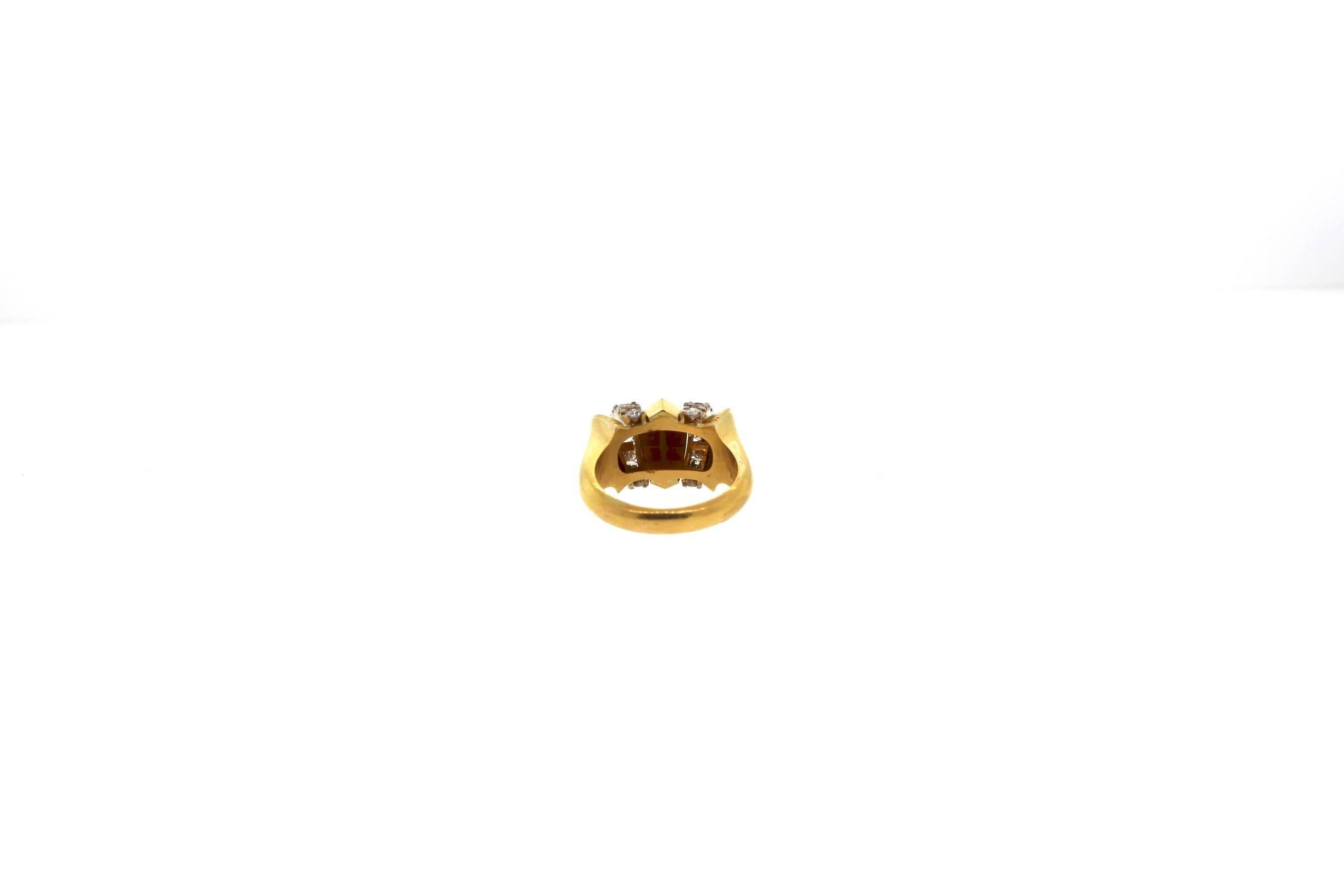 A dimensional 18k yellow gold Retro bombe ring accented with diamonds circa 1940.  The ring features rounded fluted elements and a pyramidal center portion that is faceted to catch light.  Sixteen single and Round diamonds accent the ring and weigh