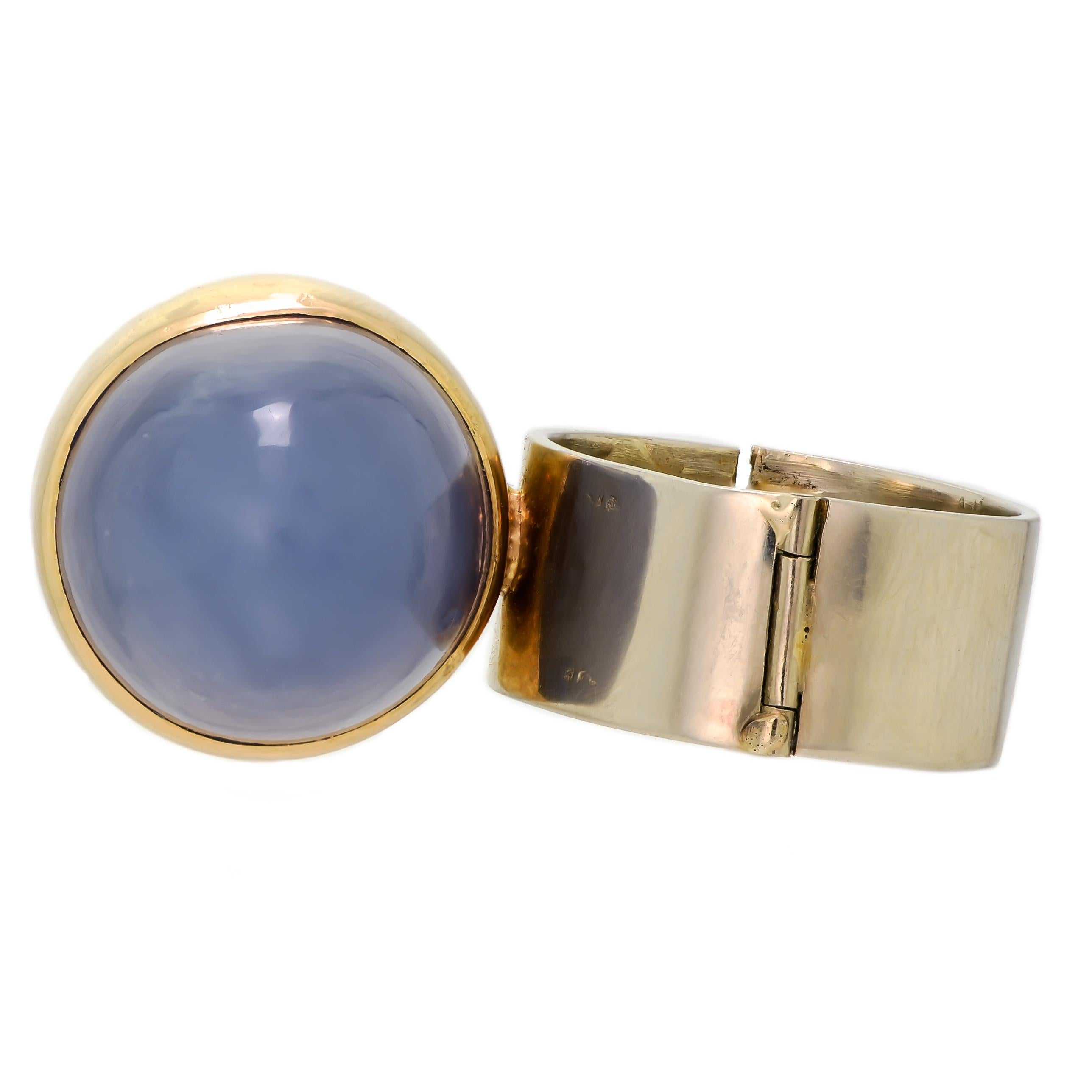 This stunning ring is a work of art that combines the natural beauty of rhodonite and blue chalcedony with the elegance of 14-karat bicolor gold. The design is modernist, with a wideband hinged structure that makes it easy to wear and remove. The
