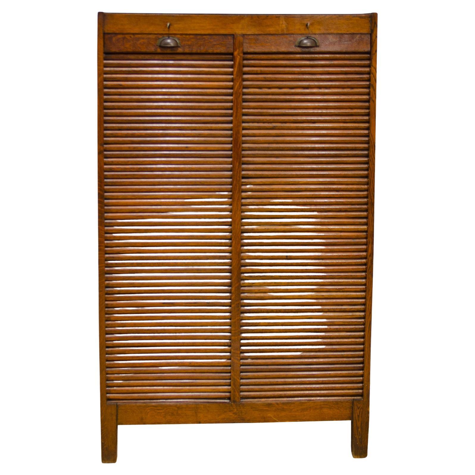 Roller blind cabinet made in the 1930s in the former Czechoslovakia. The cabinet has a rolling opening mechanism. It is suitable for the office, as well as for your apartment to store documents. It is in very good condition, it was renovated in the
