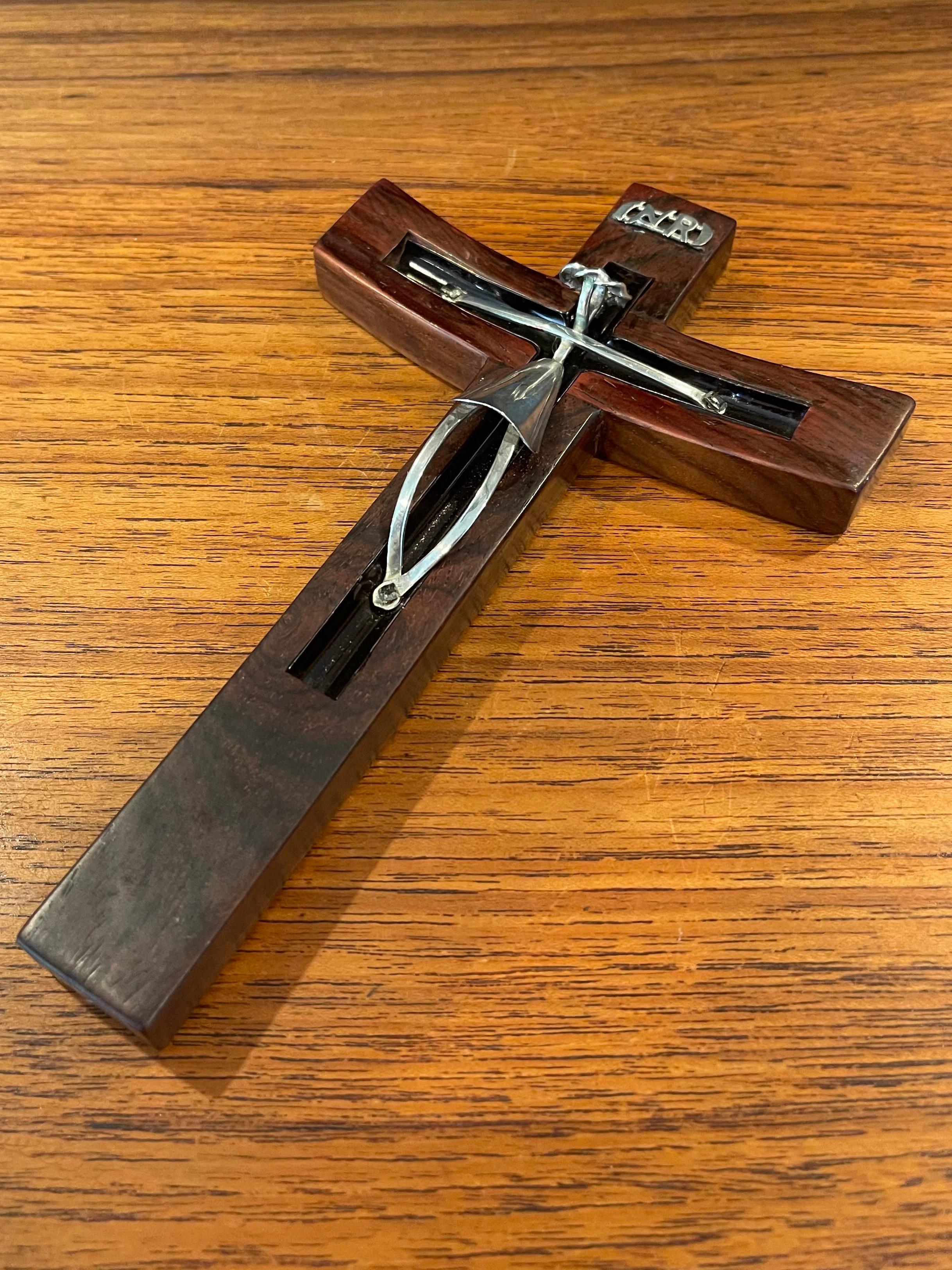 Modernist rosewood and sterling silver crucifix / cross by Taxco of Mexico, circa 1970s. The piece measures 7.75