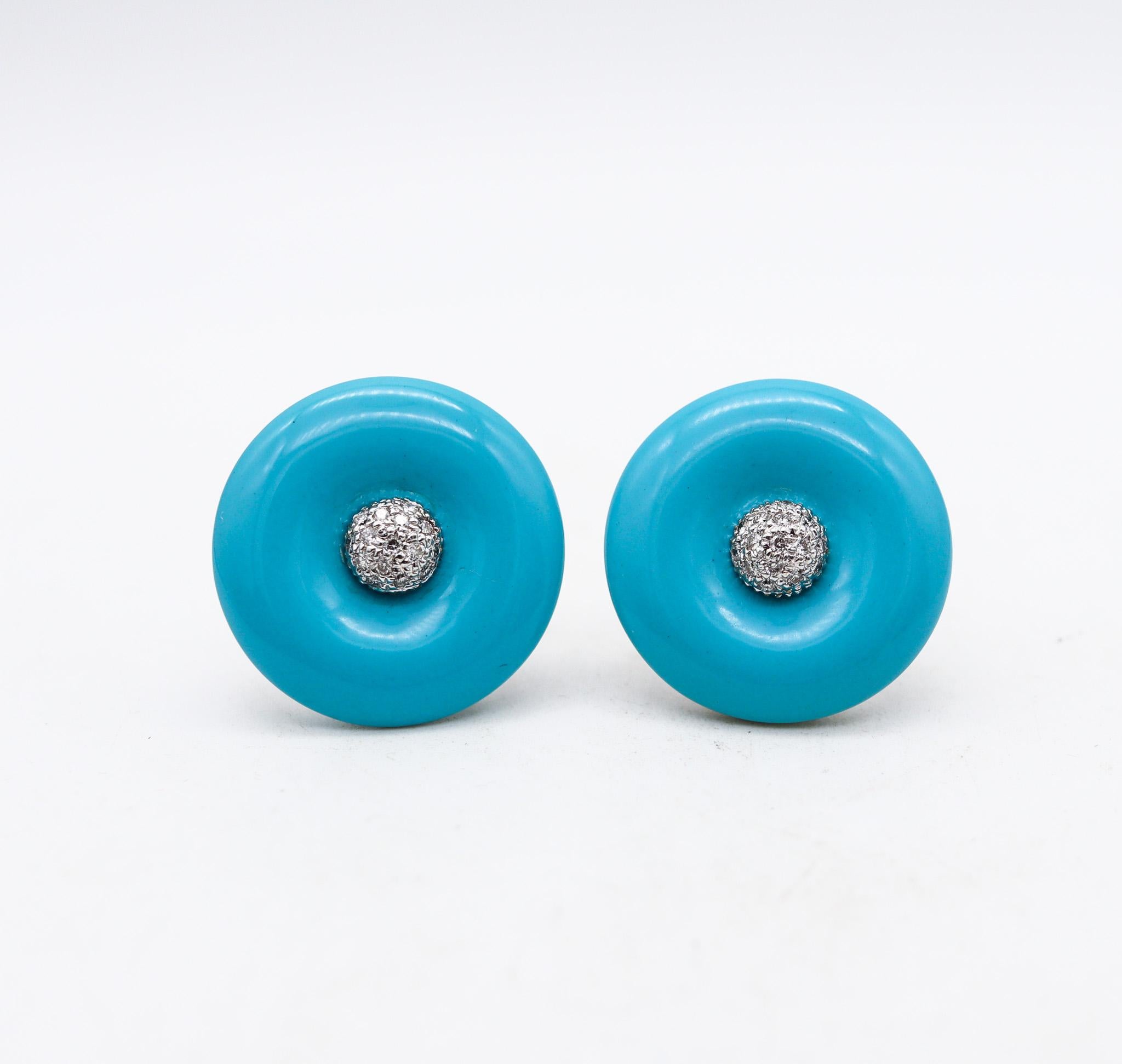 Pair of round earrings with blue sleeping turquoise.

Gorgeous and colorful pair of earrings, crafted in Italy with modernist patterns in solid white gold of 18 karats with high polished finish. They are embellished with nice even round blue