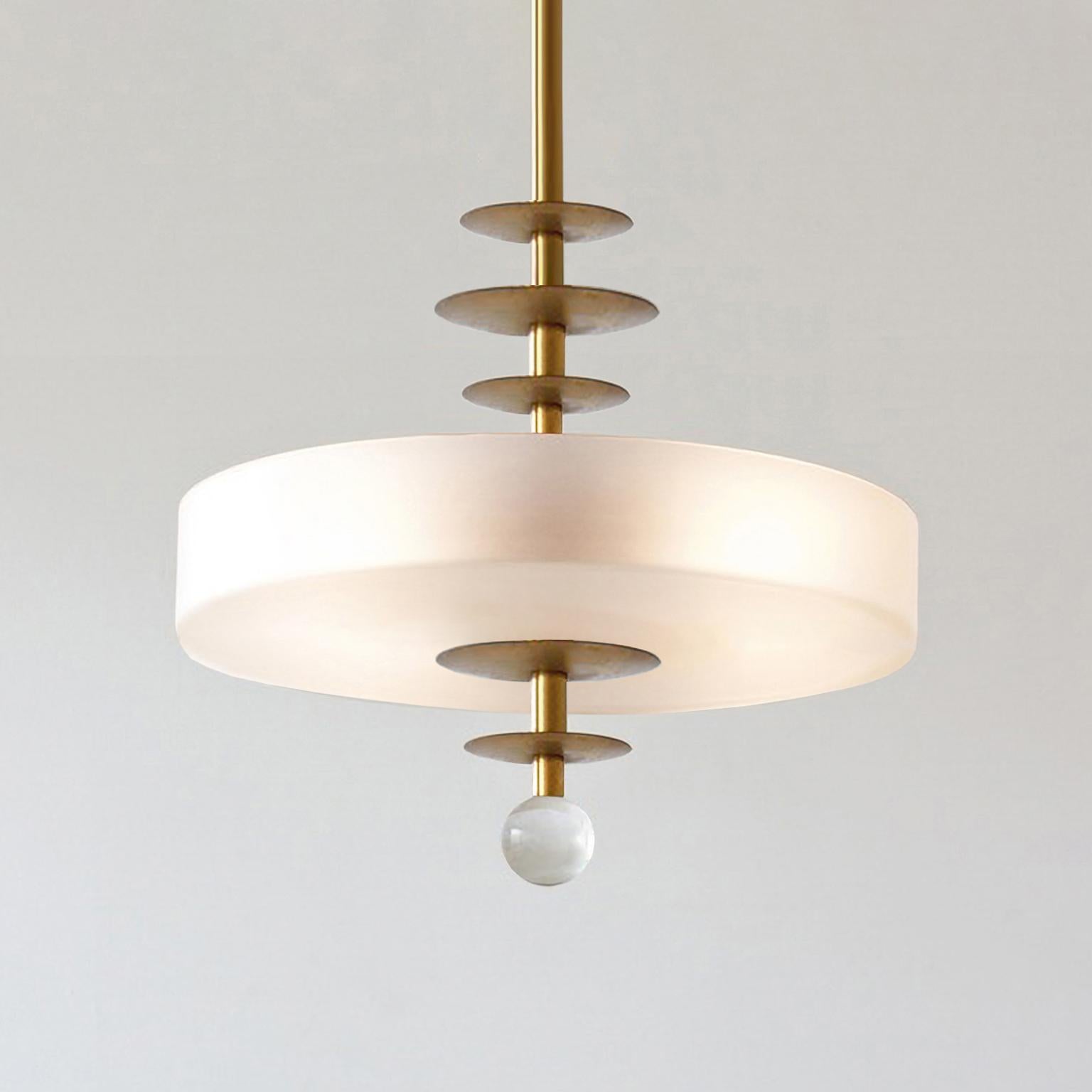 Modernist round pendant light made of brushed brass and opaline glass.
Customizable, production time c. 10 weeks.