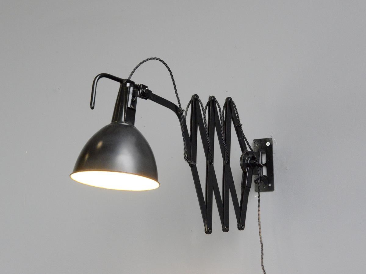 Modernist scissor lamp by Wilhelm Bader, circa 1930s

- Large extendable scissor mechanism 
- Original On/Off switches 
- Takes E27 fitting bulbs
- German ~ 1930s
- Extends up to 115cm from the wall
- Measures: 18cm wide x 25cm