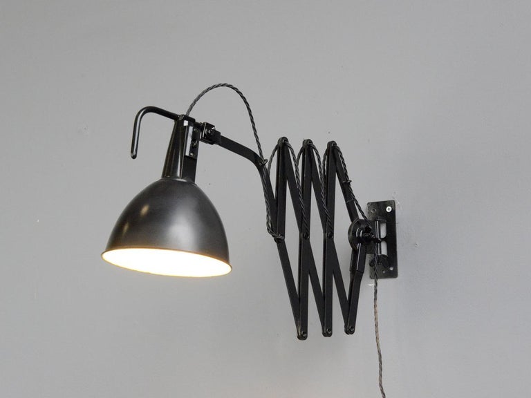 Modernist scissor lamp by Wilhelm Bader, circa 1930s

- Large extendable scissor mechanism 
- Original On/Off switches 
- Takes E27 fitting bulbs
- German ~ 1930s
- Extends up to 115cm from the wall
- Measures: 18cm wide x 25cm