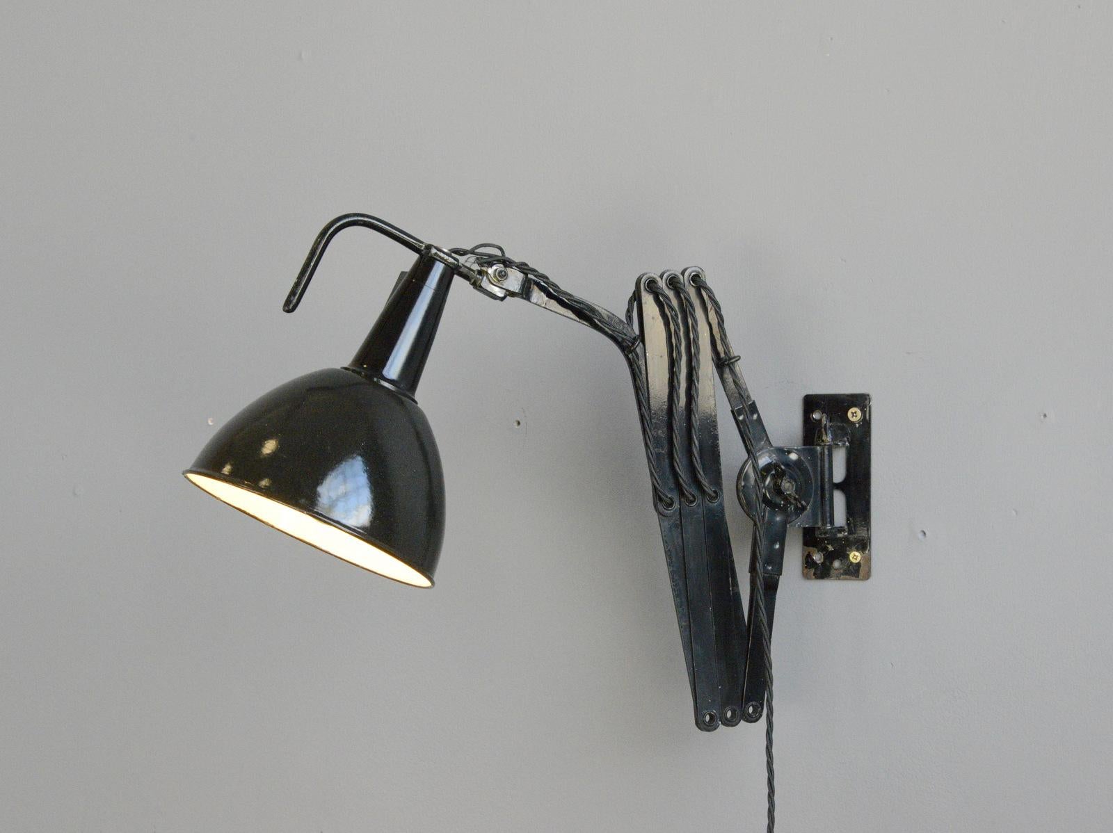 Modernist scissor lamp by Wilhelm Bader, circa 1930s

- Large extendable scissor mechanism 
- Vitreous black enamel shade
- Original on/off switches 
- Takes E27 fitting bulbs
- German, 1930s
- Extends up to 115cm from the wall
- Measures: