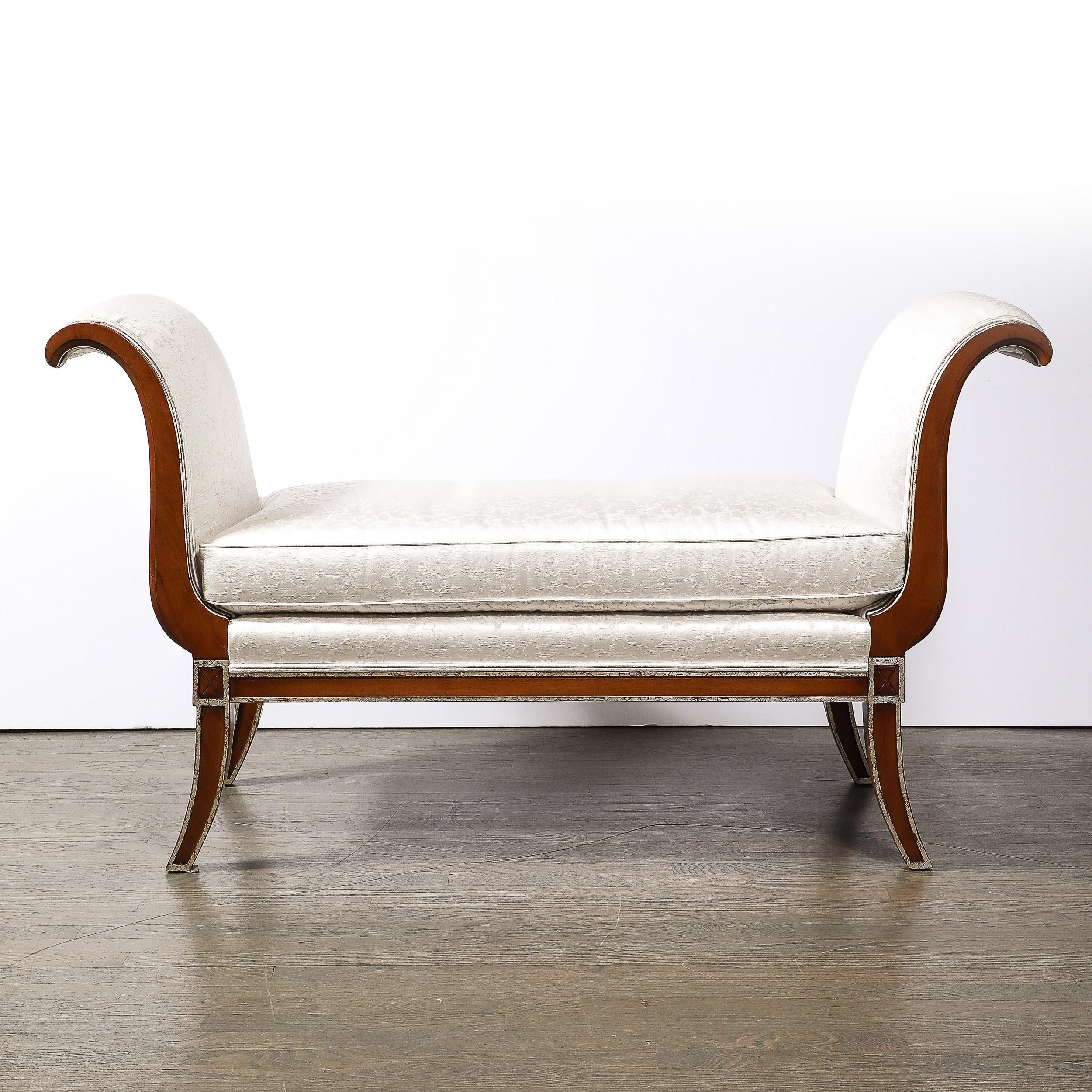 This elegant and well scaled Modernist Scroll Form Bench in Walnut With Silver Naturalist Upholstery originates from the United States during the latter half of the 20th Century. Featuring scroll form supports to either side of the seat, following