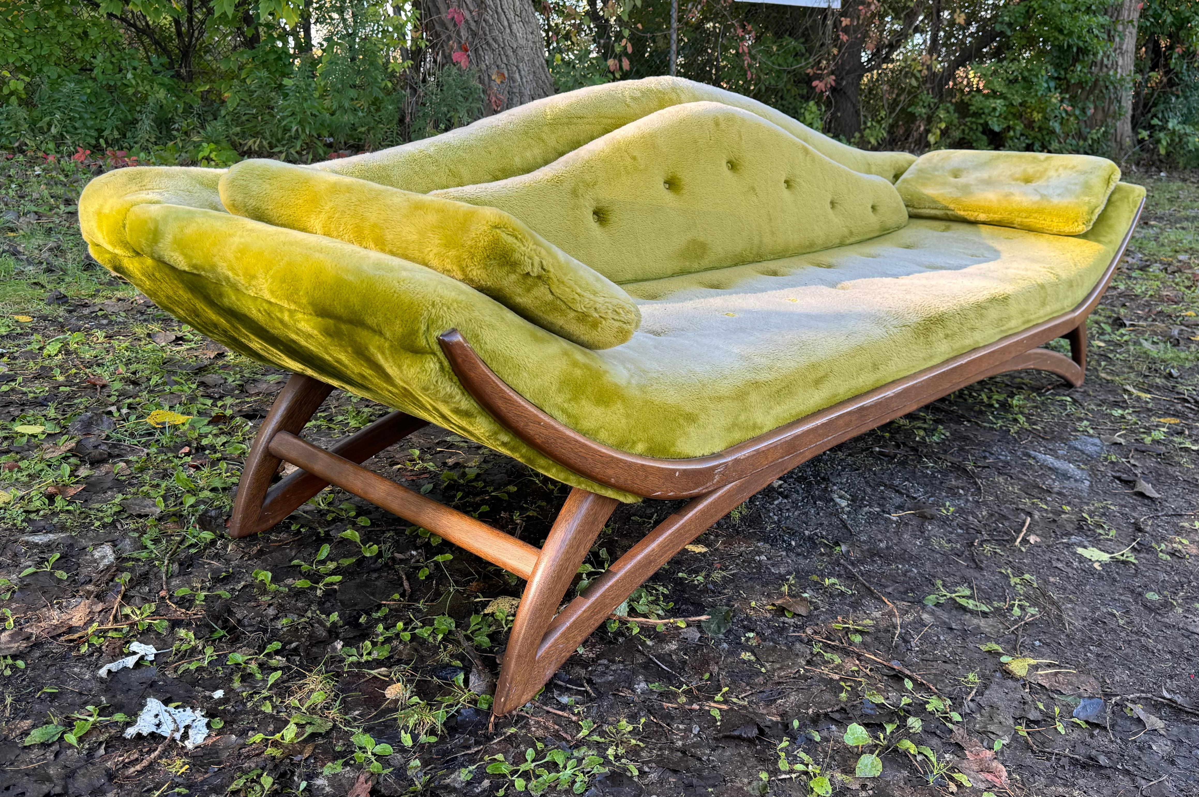 The aptly named Adrian Pearsall Gondola Sofa is bold in its design, so clearly translating the character of a Venetian gondola to create a unique silhouette in a sophisticated living room. retaining its original fabric,, some fading. , lending a