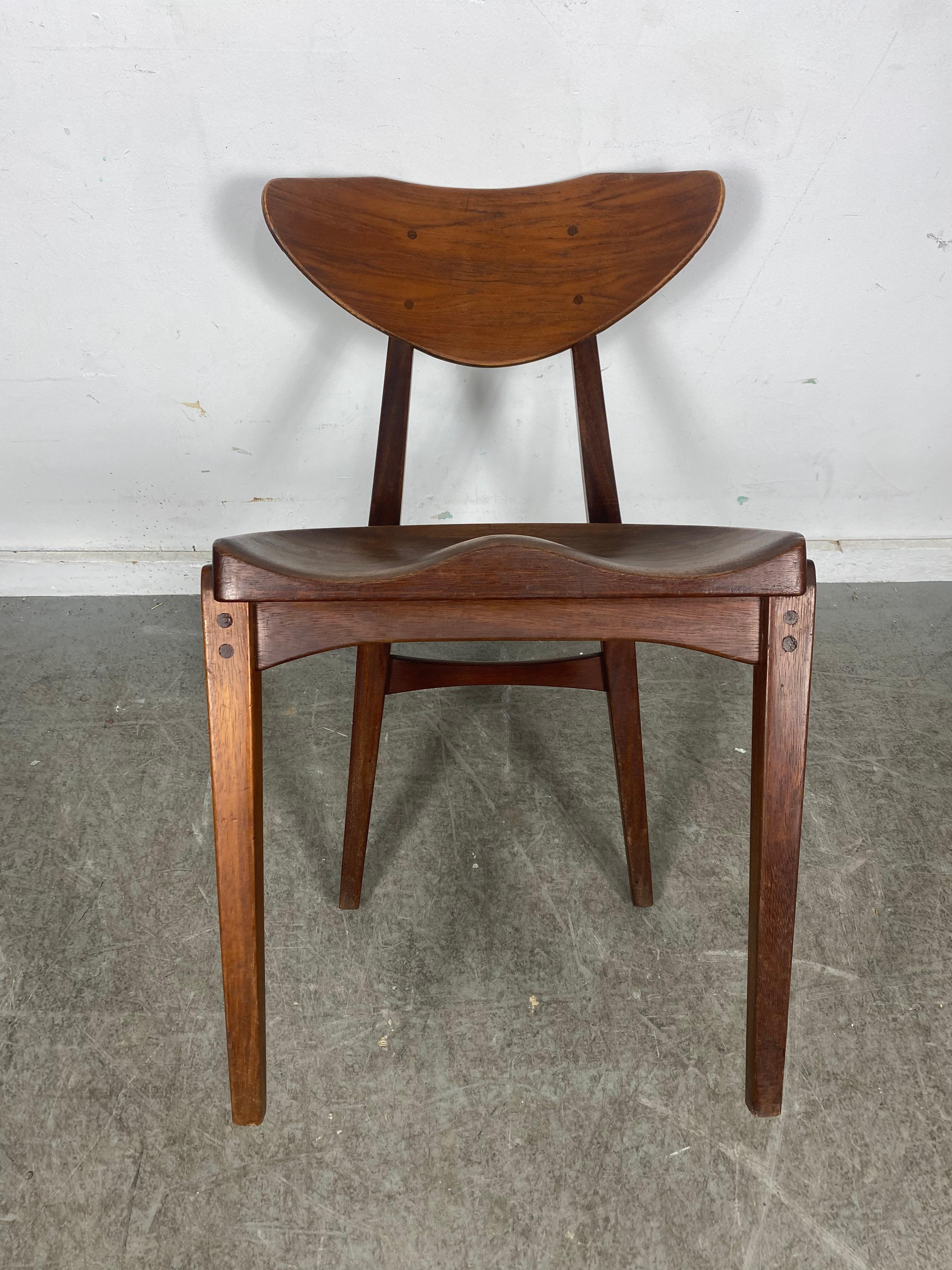 Richard Jensen and Kjaerulff Rasmussen, teak, Denmark, 1960s

This striking teak dining / desk chair was designed by Richard Jensen and Kjaerulff Rasmussen. What characterizes the chair is the combination of angled frame and organic shaped seat