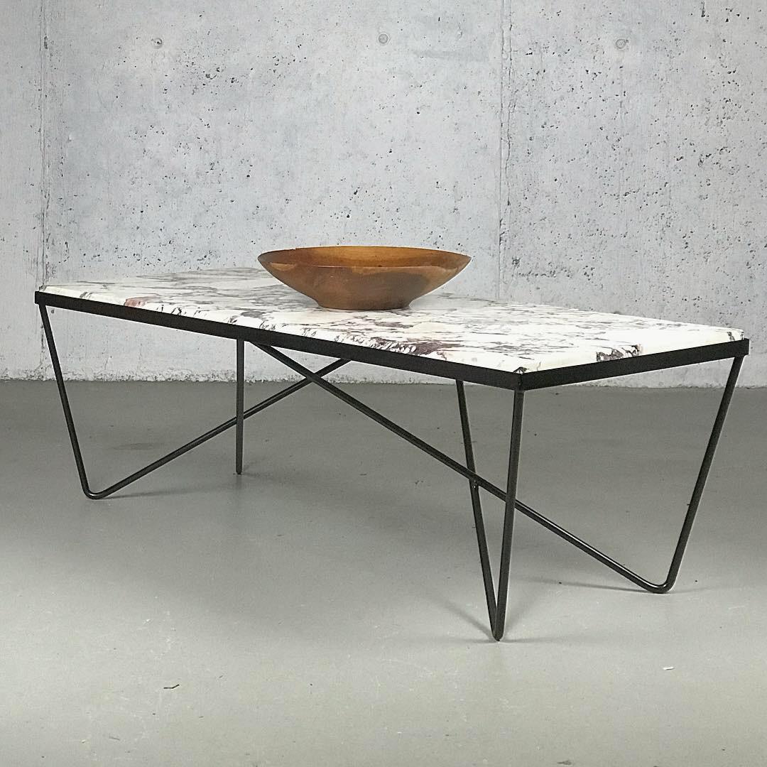 Excellent Minimalist iron and marble sculptural coffee table after Darrell Landrum. Maker unknown. Restored the iron frame. Removed oxidation and primed and painted semi-gloss black. The marble tabletop has wear but no major issues. Marble has many