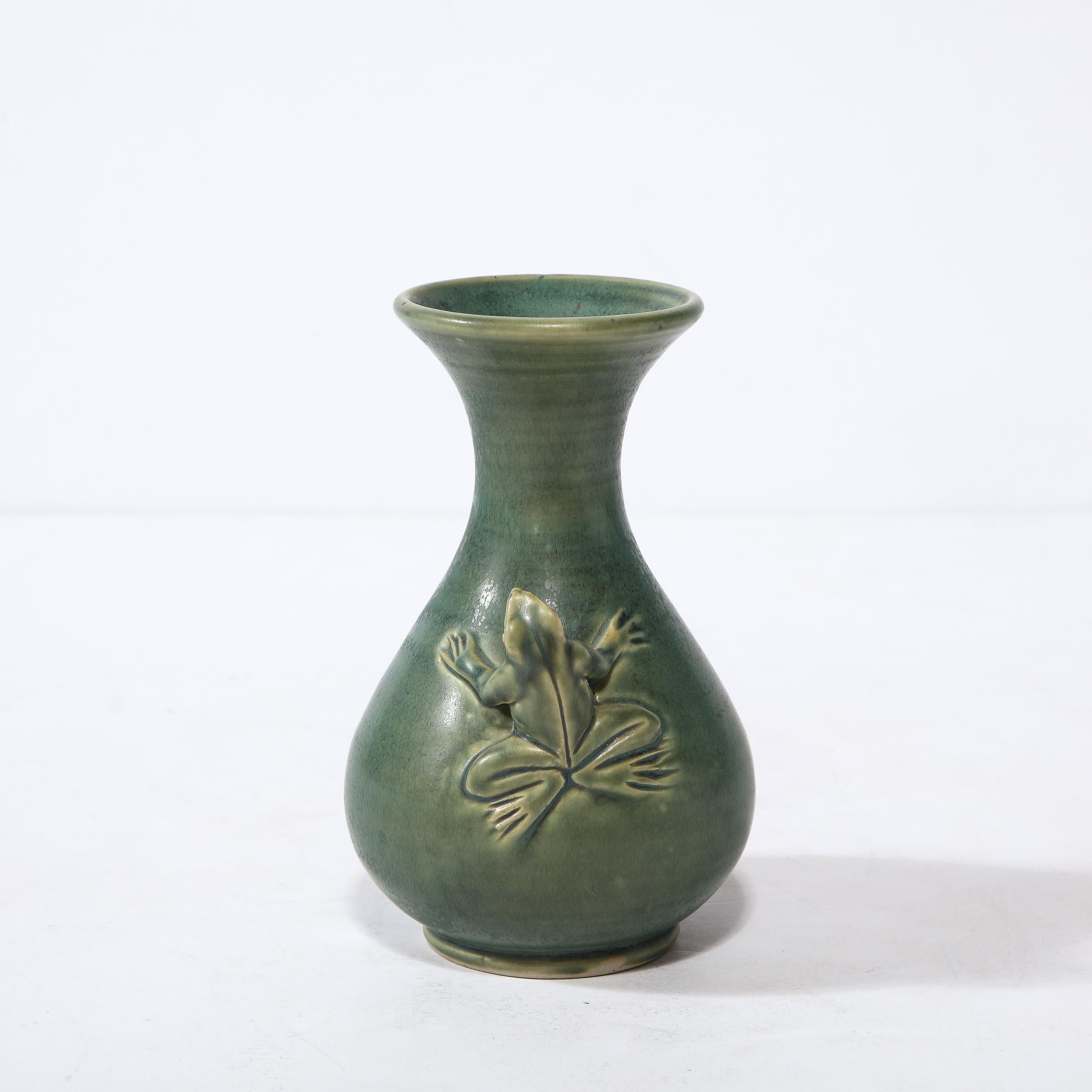 This sophisticated and whimsical modernist ceramic vase was realized in Indonesia during the latter half 20th century. It features a sculptural undulating Silhouette with a protuberant body that dramatically narrows at the neck before flaring to its